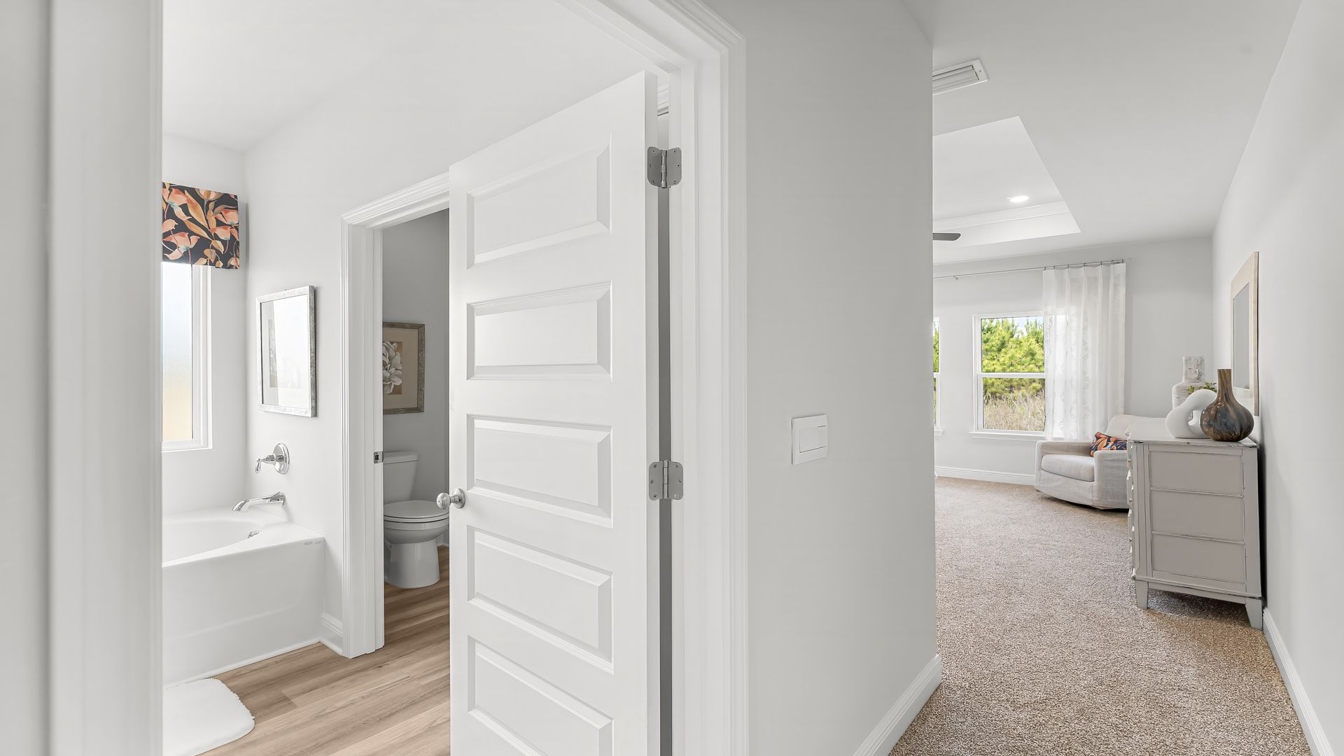 Primary bedroom with primary bathroom entrance.
