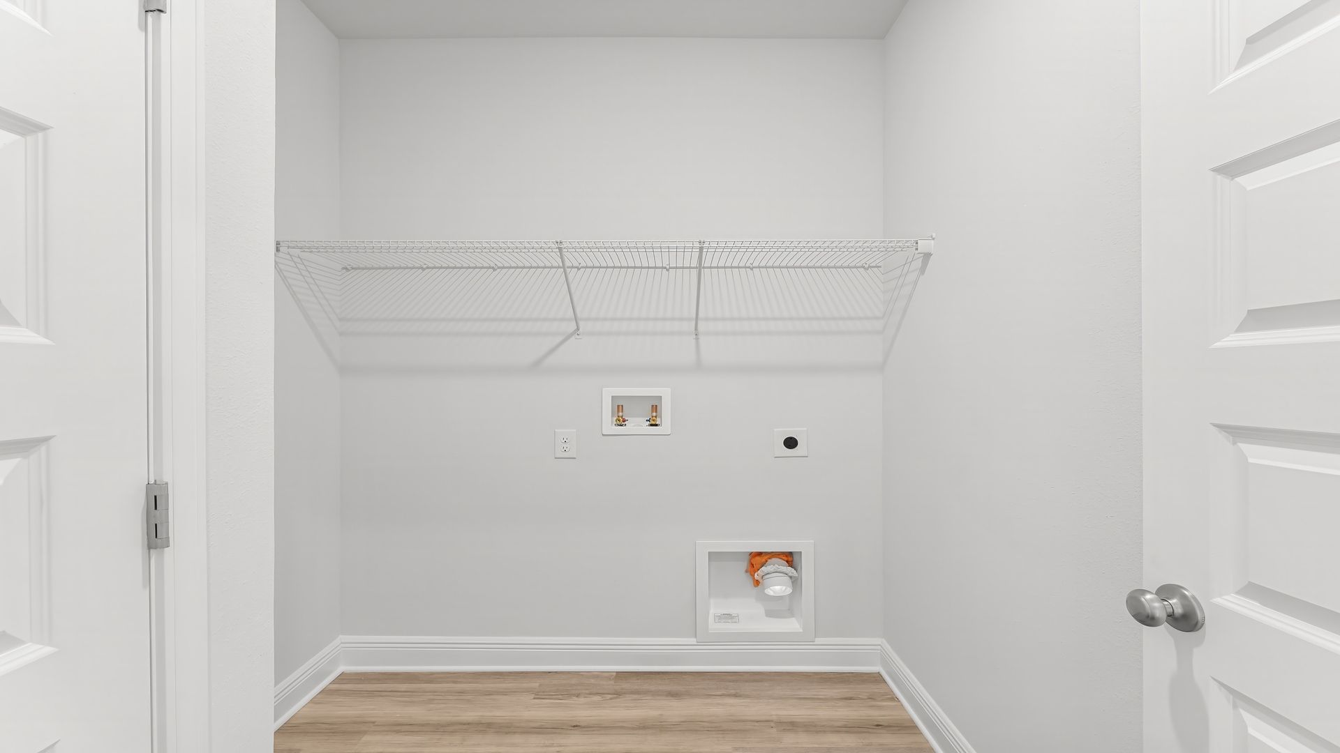 Laundry room with EVP flooring and ventilated shelving.