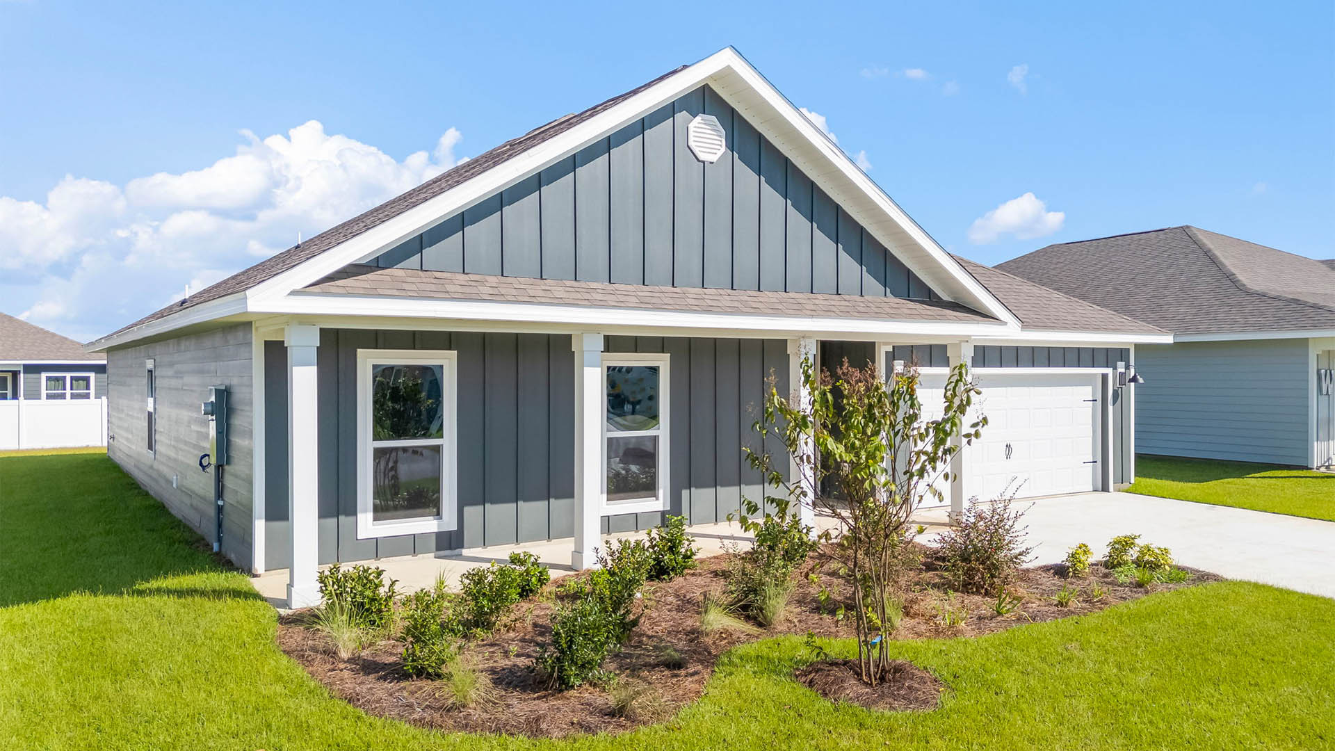 Victoria floor plan at Liberty with Hardie Board siding and large covered front porch and two car garage.