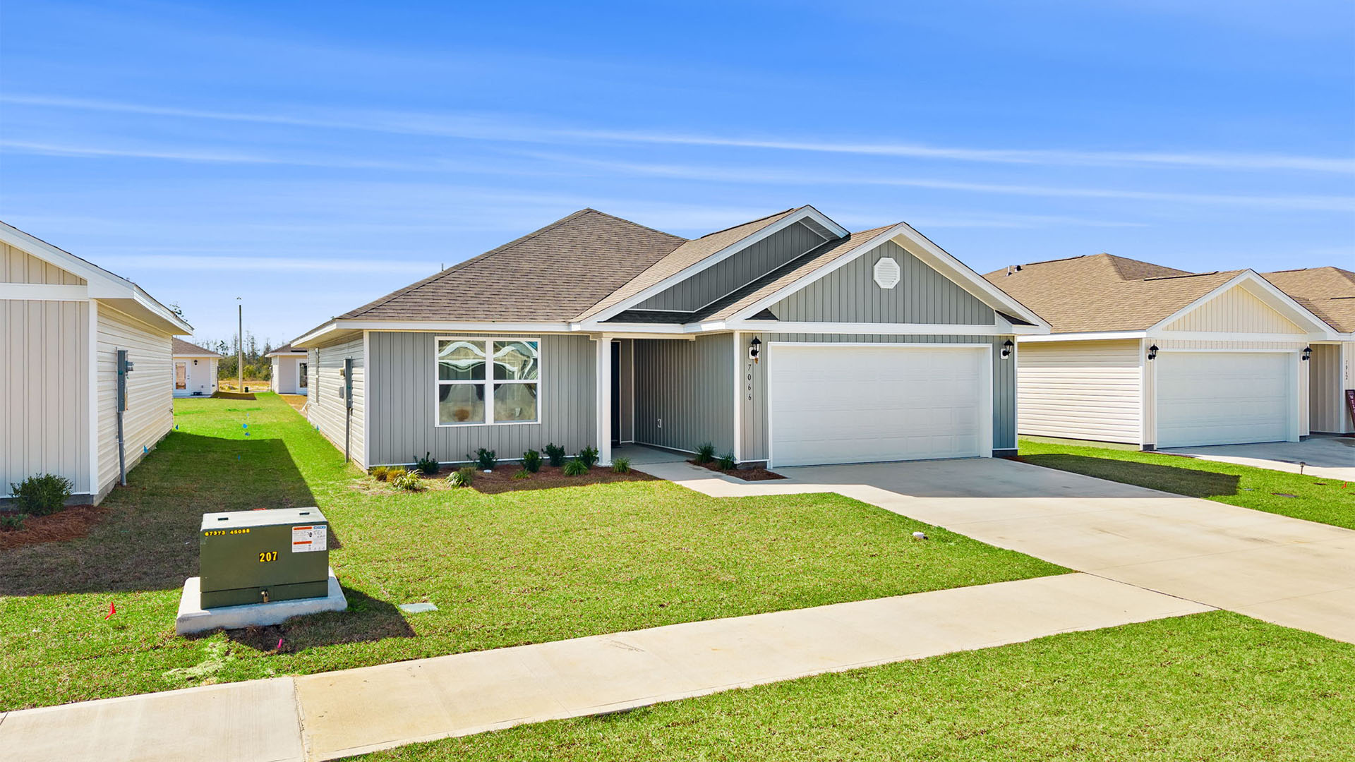 Lismore front of home with vinyl siding and two car garage.