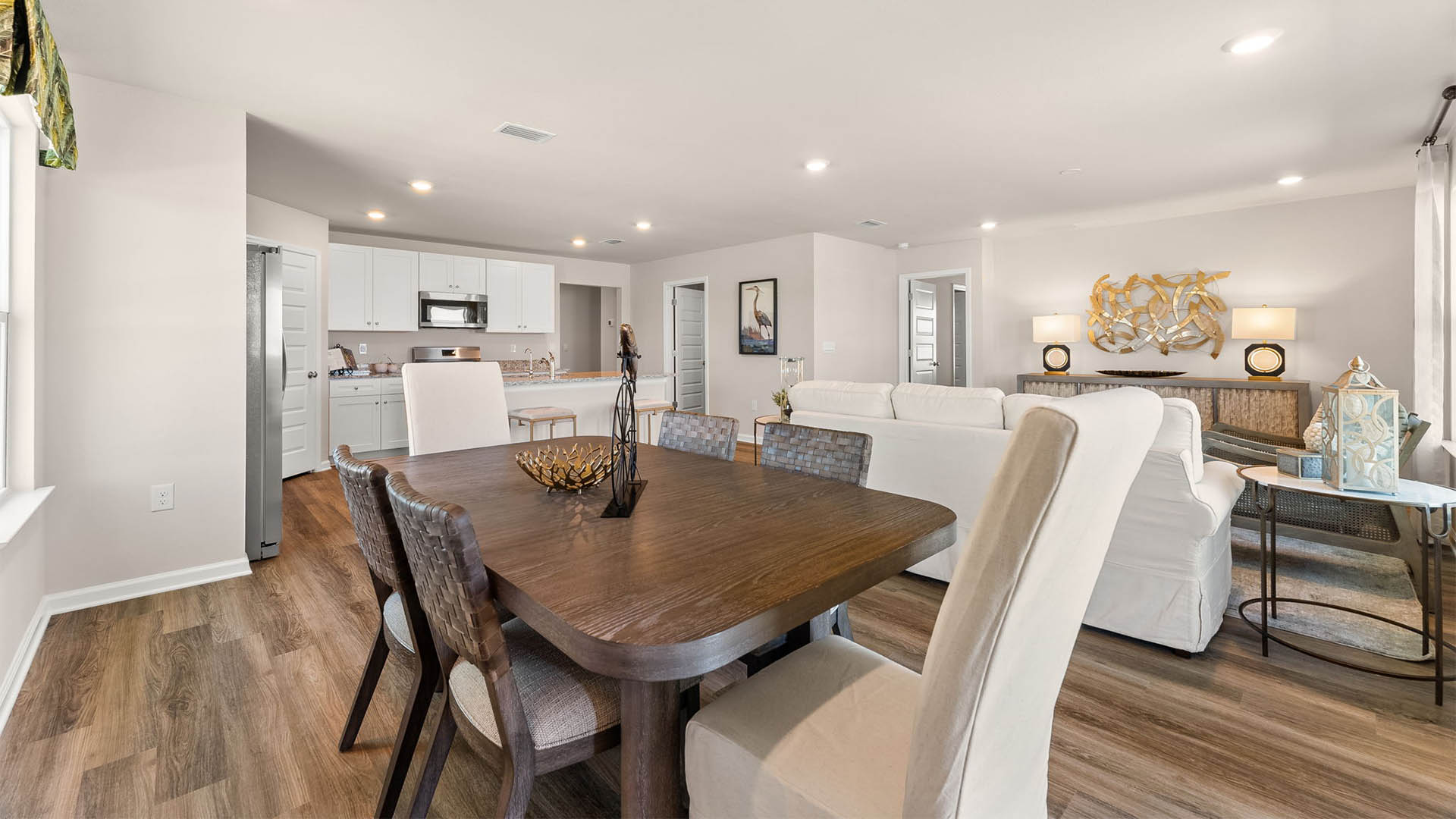 Dining area and kitchen and living room with EVP flooring throughout.