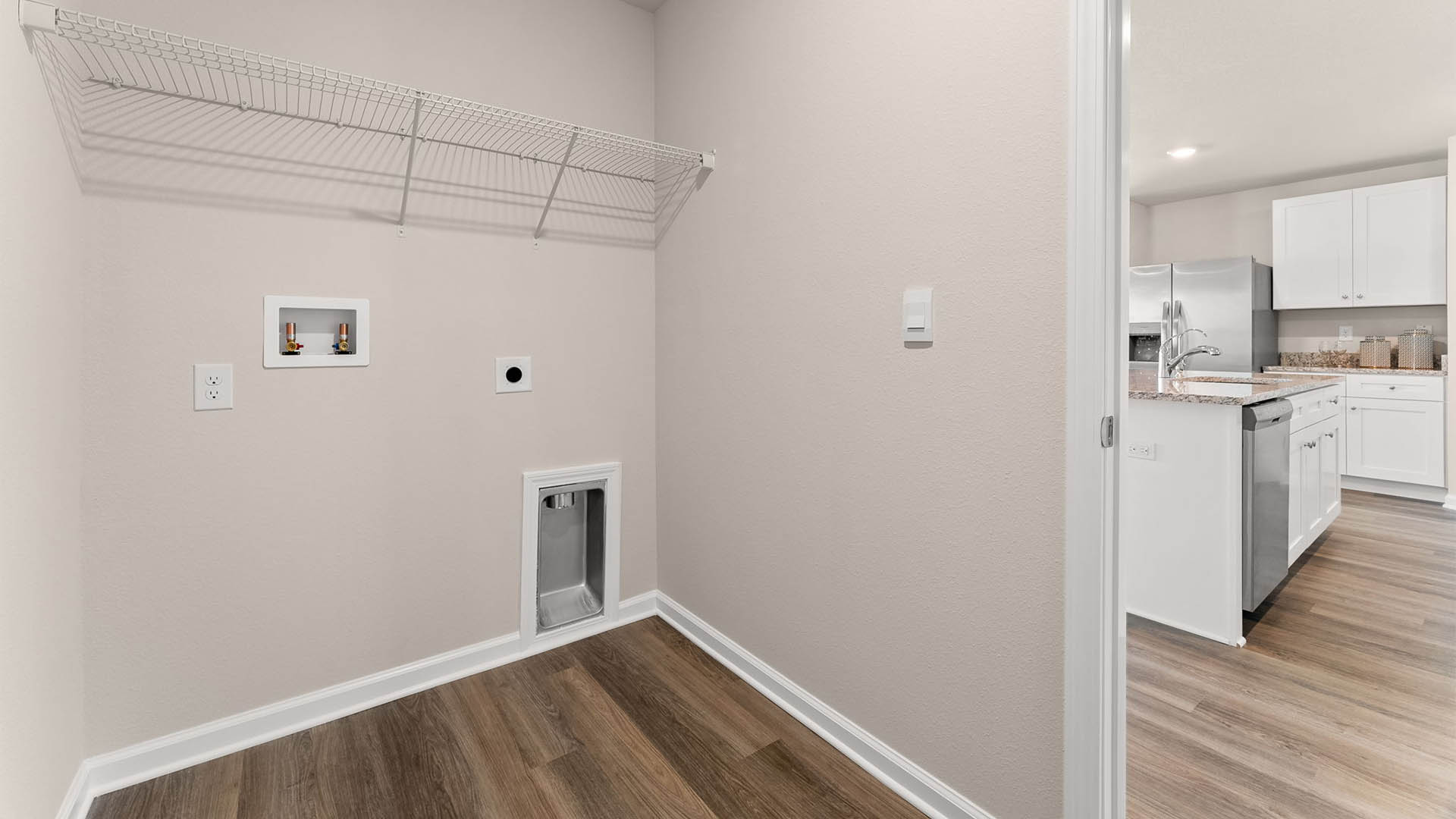 Laundry room with EVP flooring and ventilated shelving.
