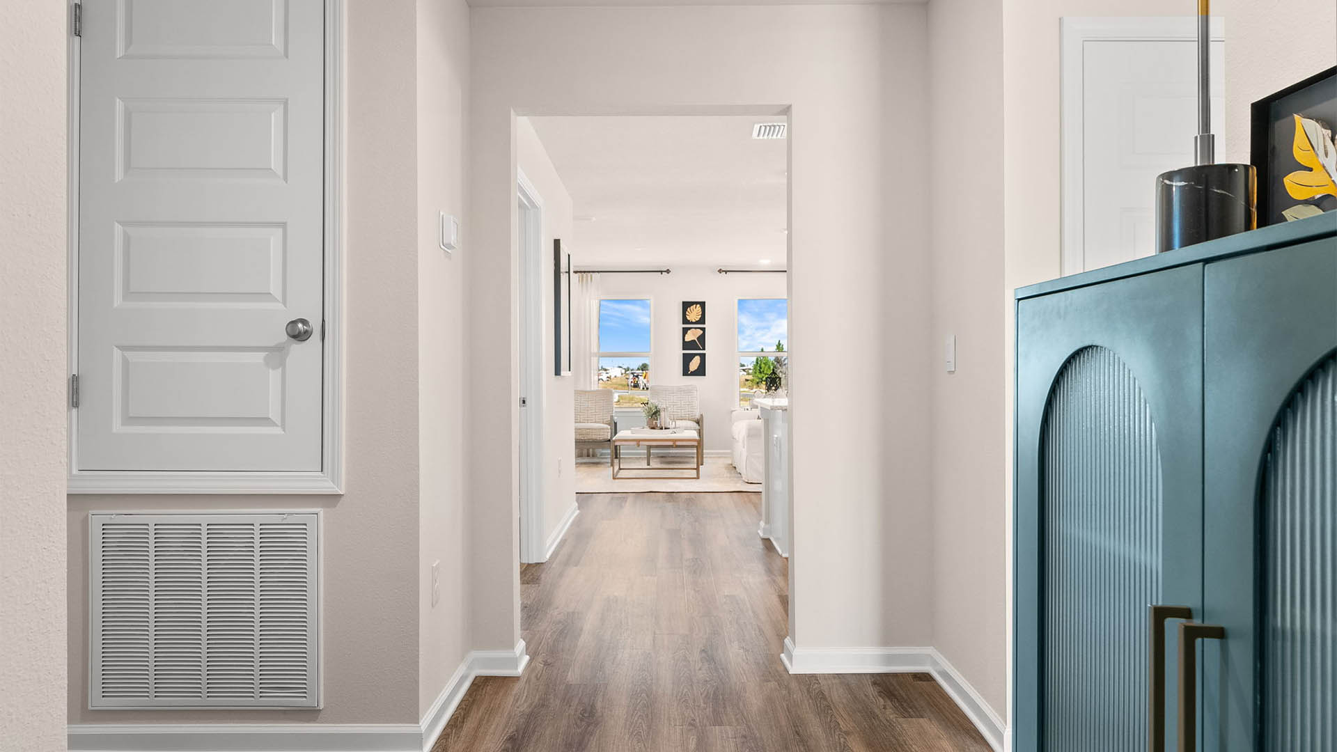 Front hallway next to front door and bedrooms and bathroom and garage.