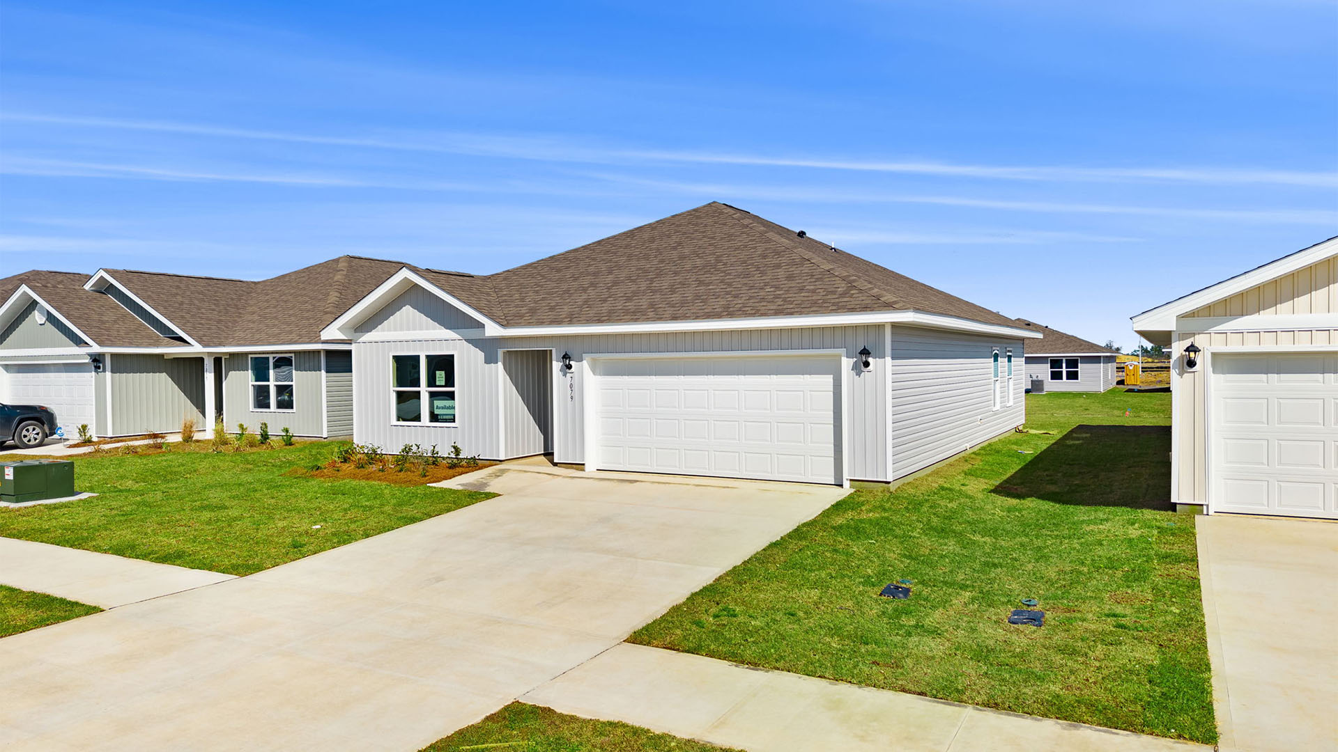 Aldridge plan with vinyl siding and two car garage.
