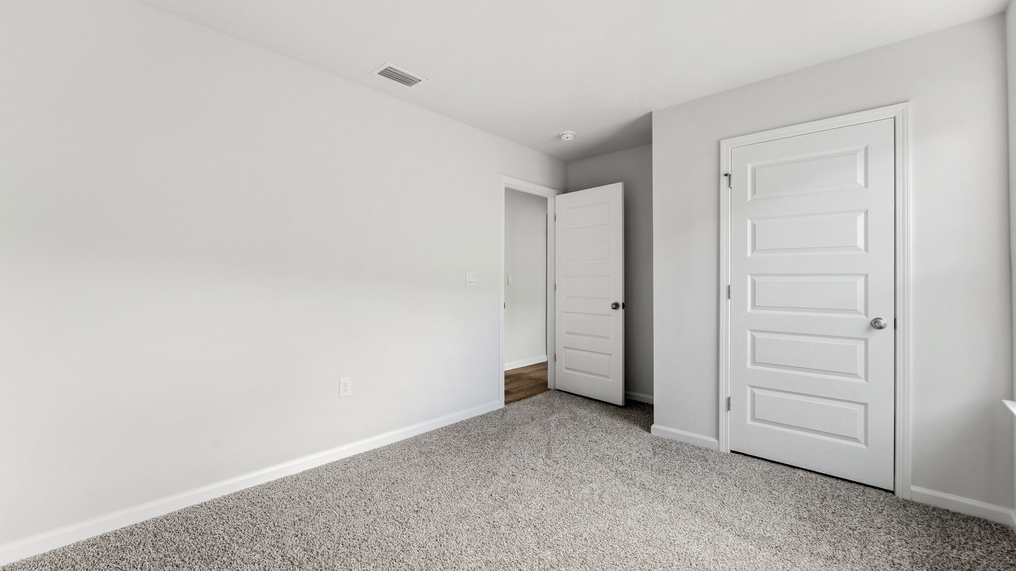 Bedroom with carpet floors and closet.