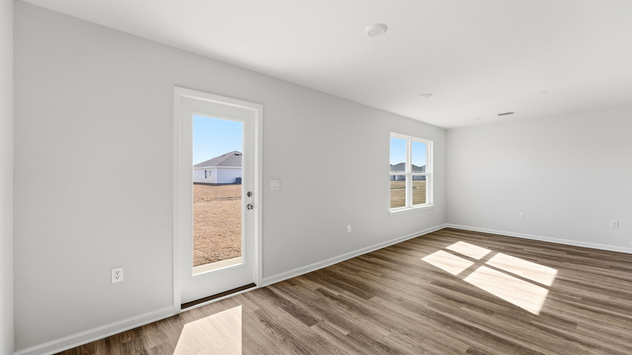 Dining area and living room next to back door.