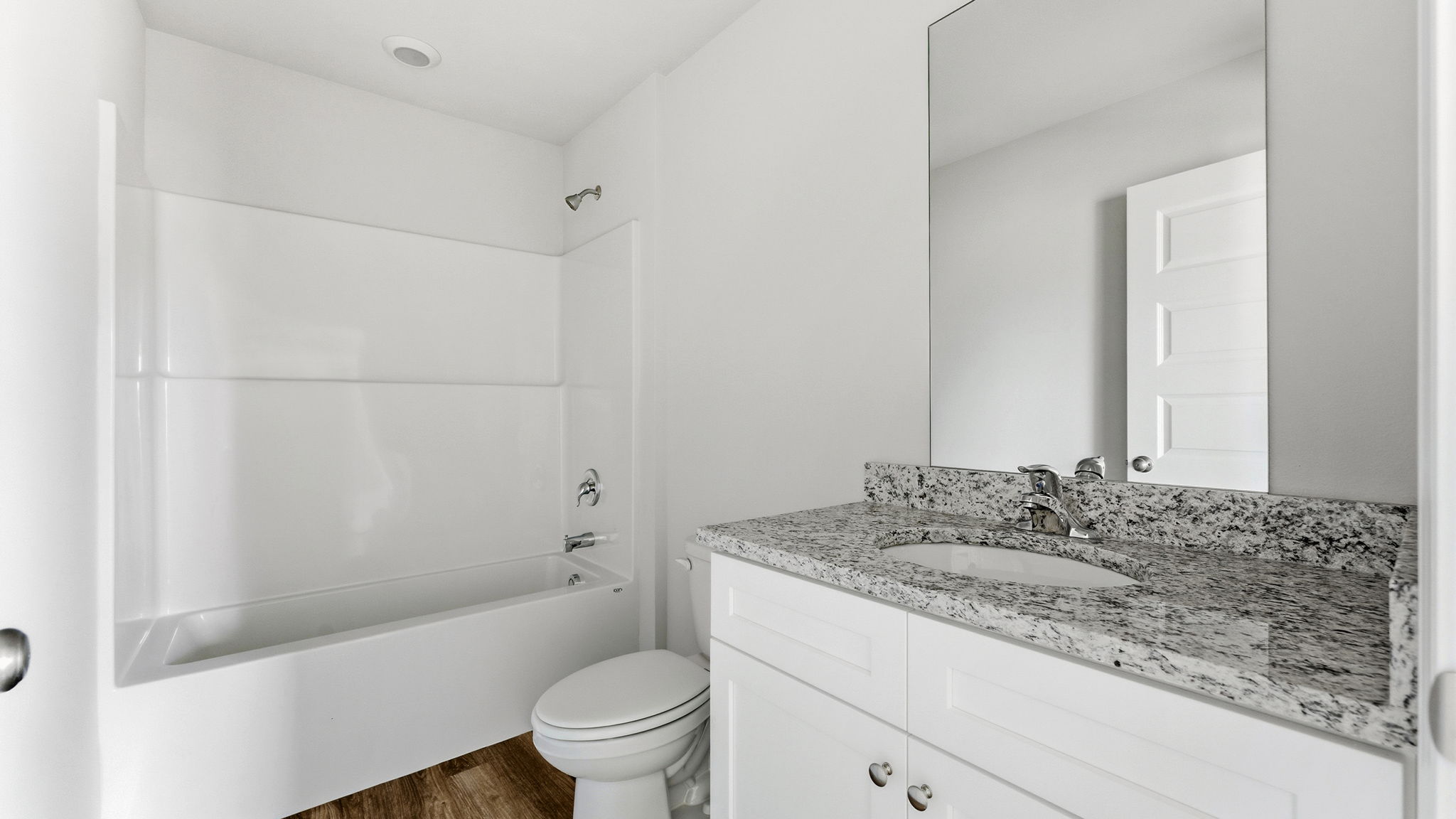 Bathroom with granite countertops and single vanity and shower and tub.