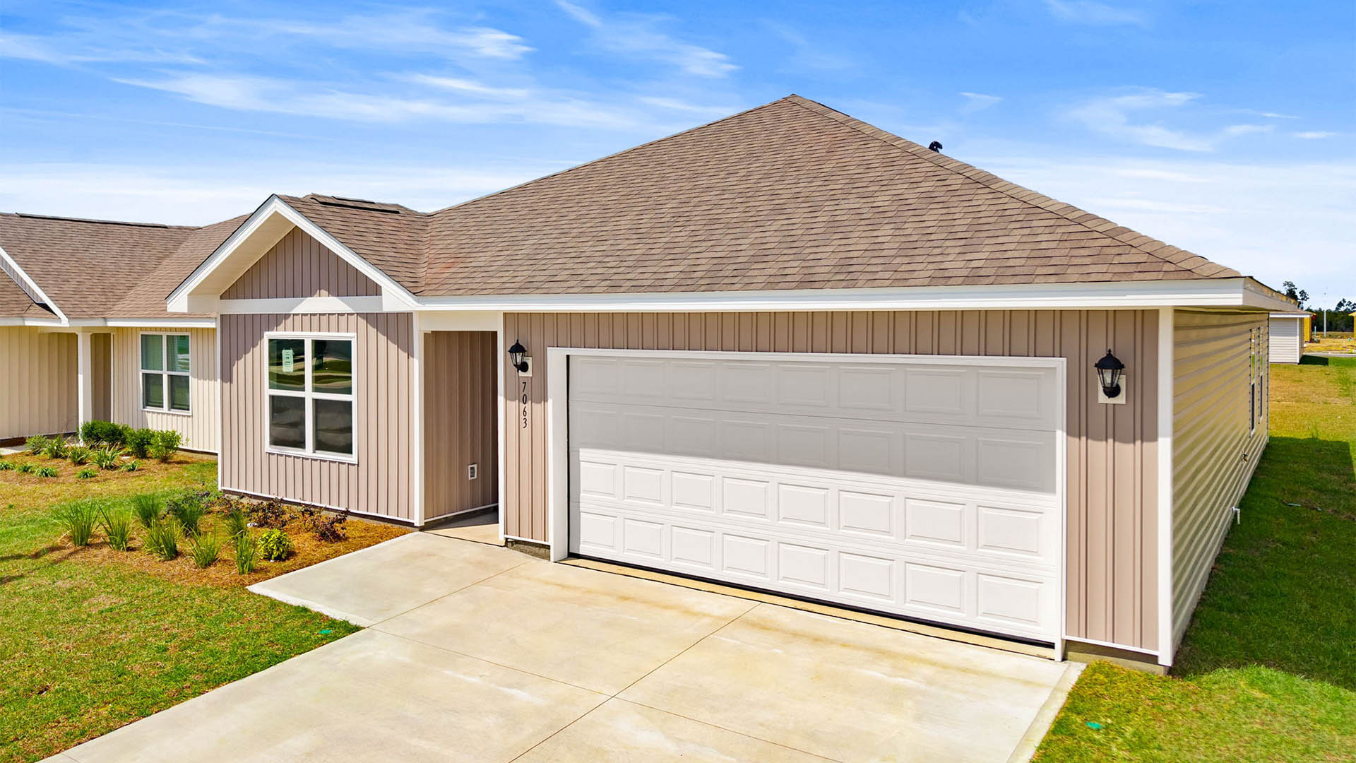 Aldridge plan with vinyl siding and two car garage.
