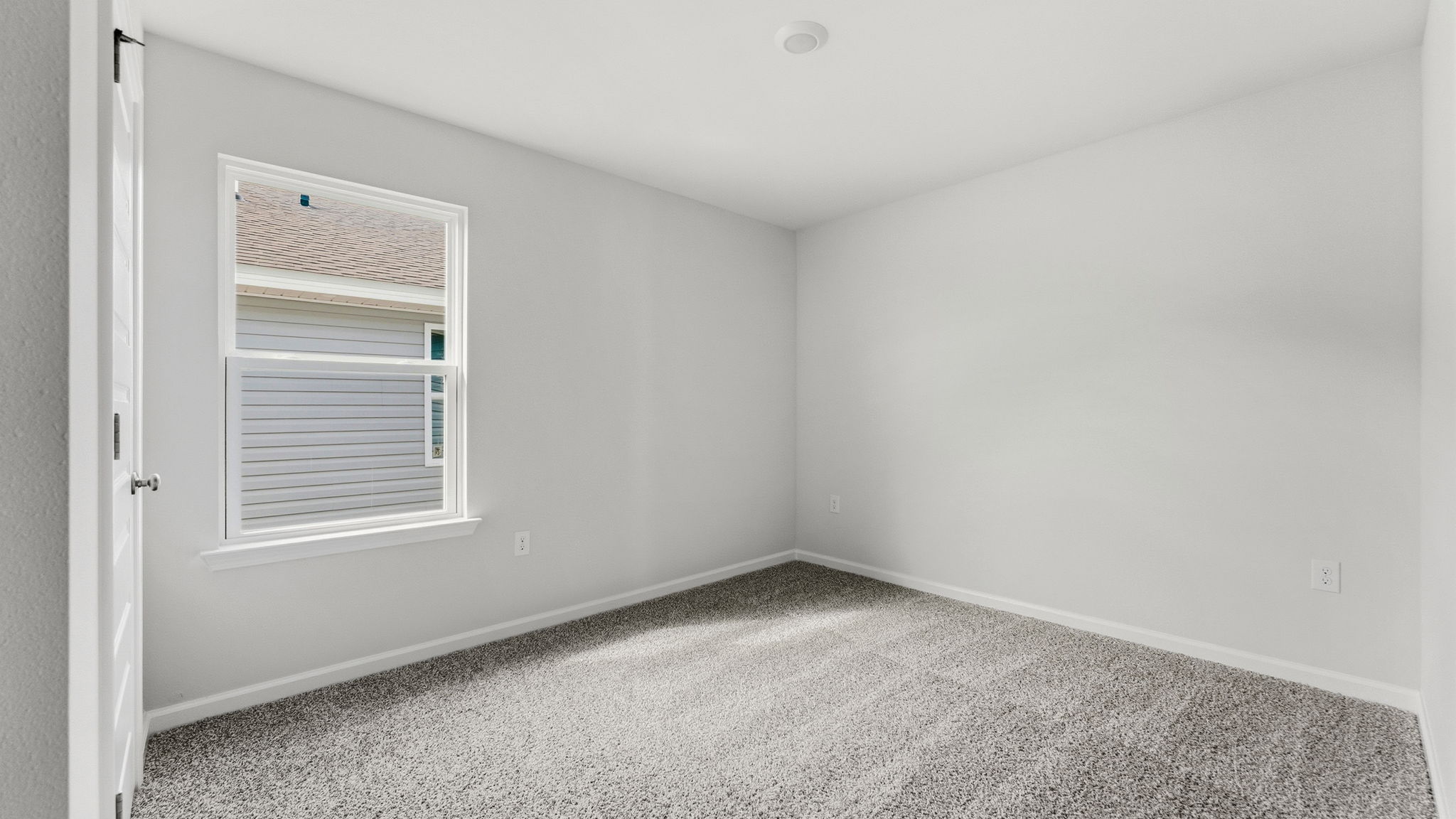 Bedroom with carpet floors and window and closet.