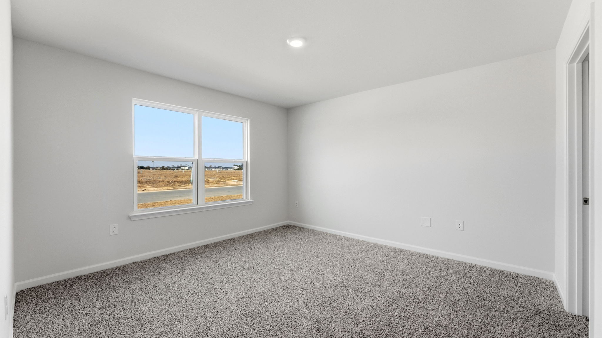 Bedroom with carpet floors and window and closet.