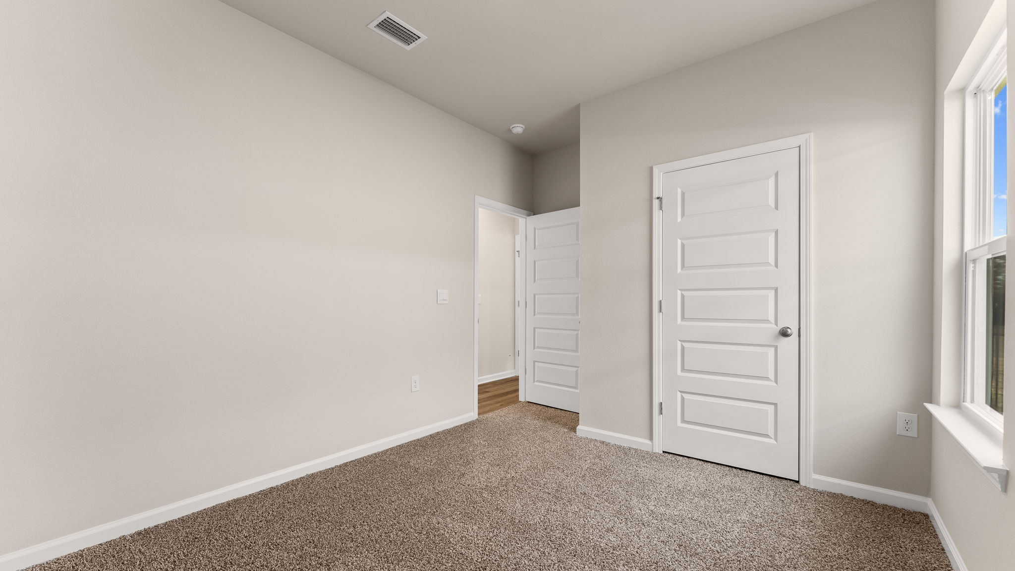 Bedroom with carpet floor and window and closet.