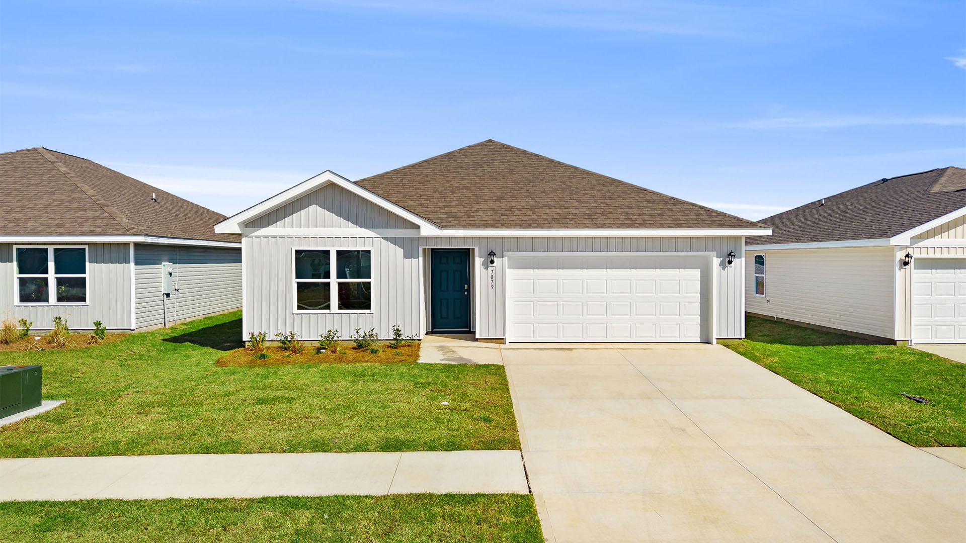 Aldridge plan with vinyl siding and two car garage.