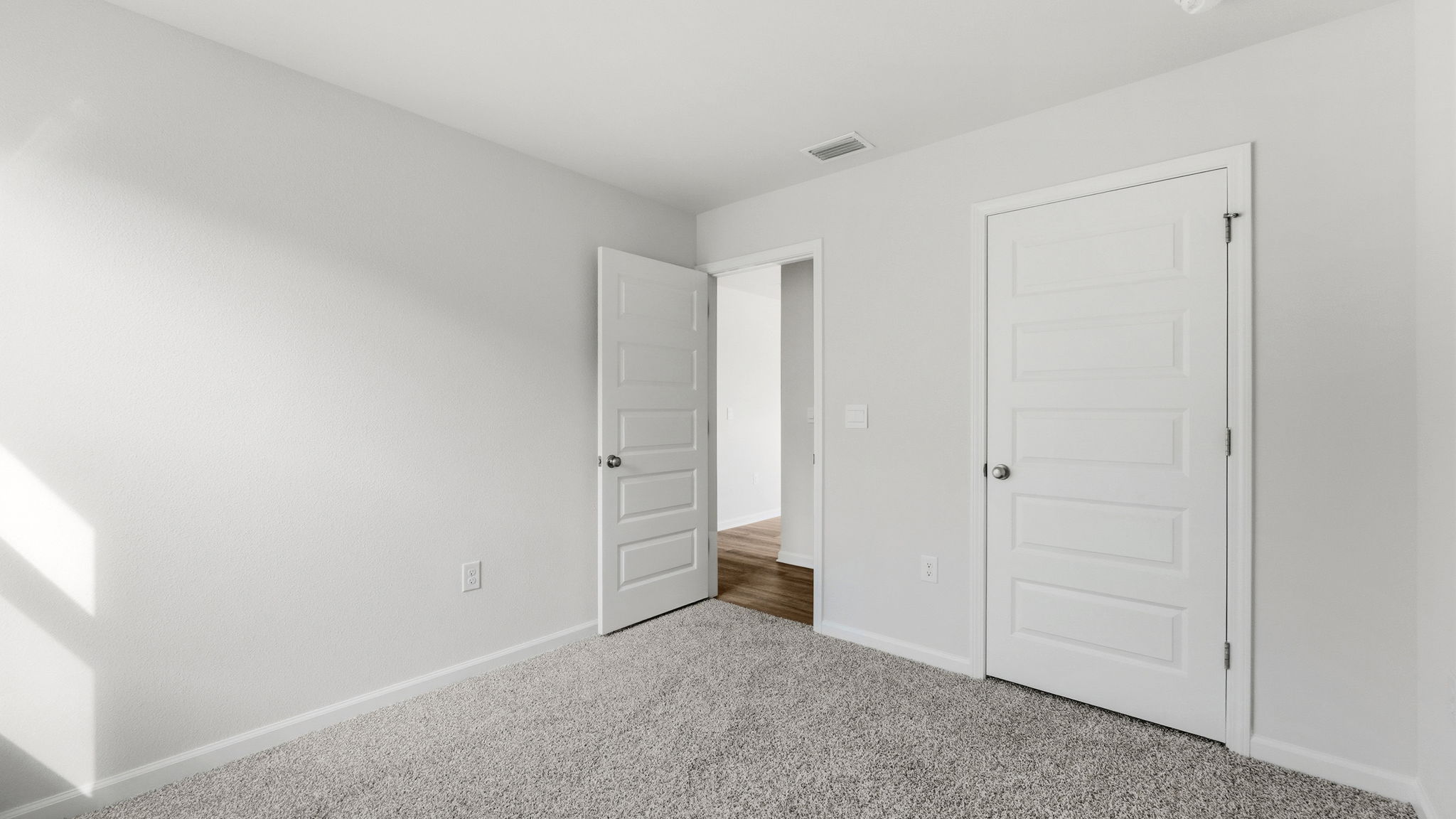 Bedroom with carpet floors and closet.