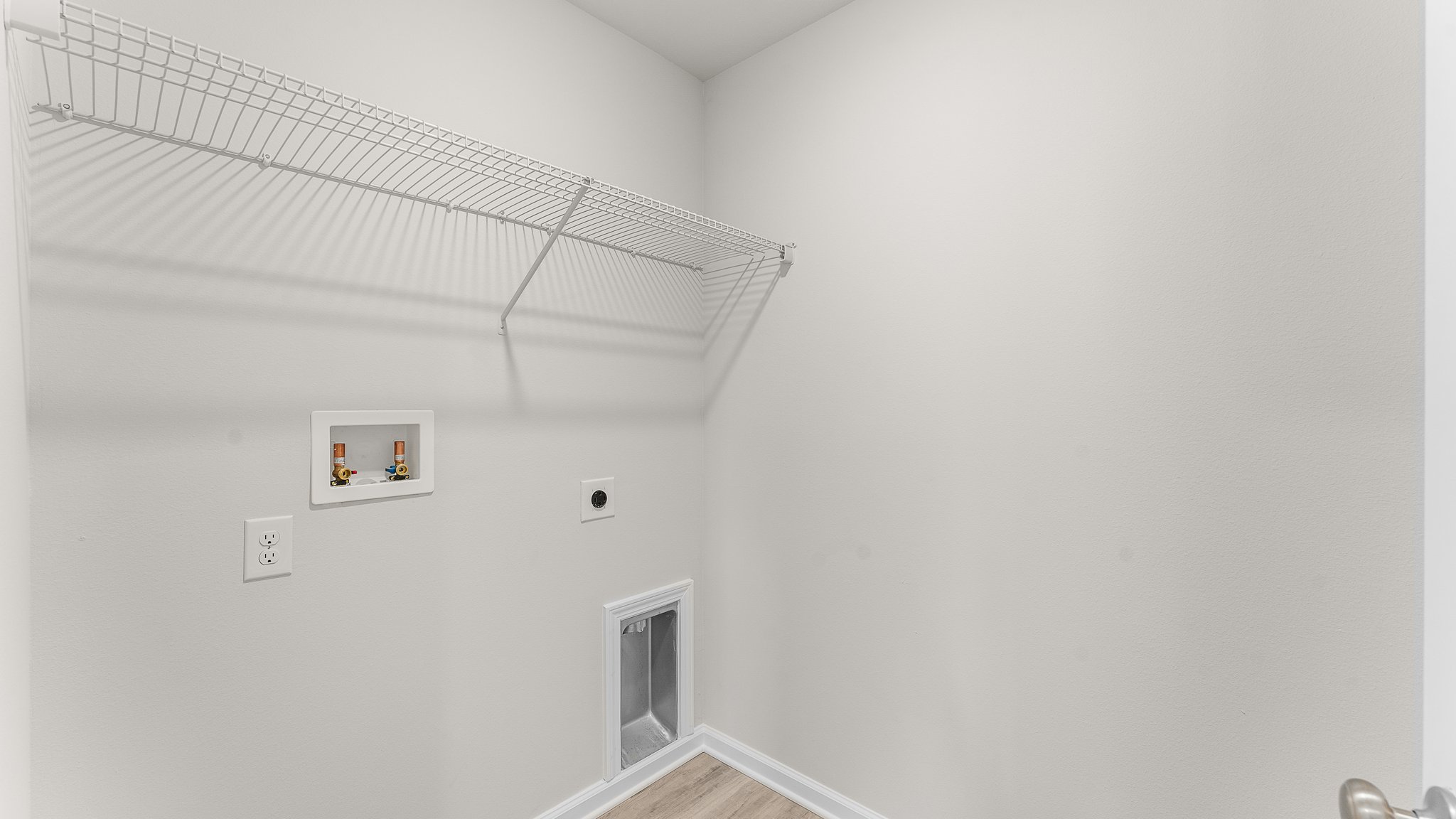 Laundry room with ventilated shelving.