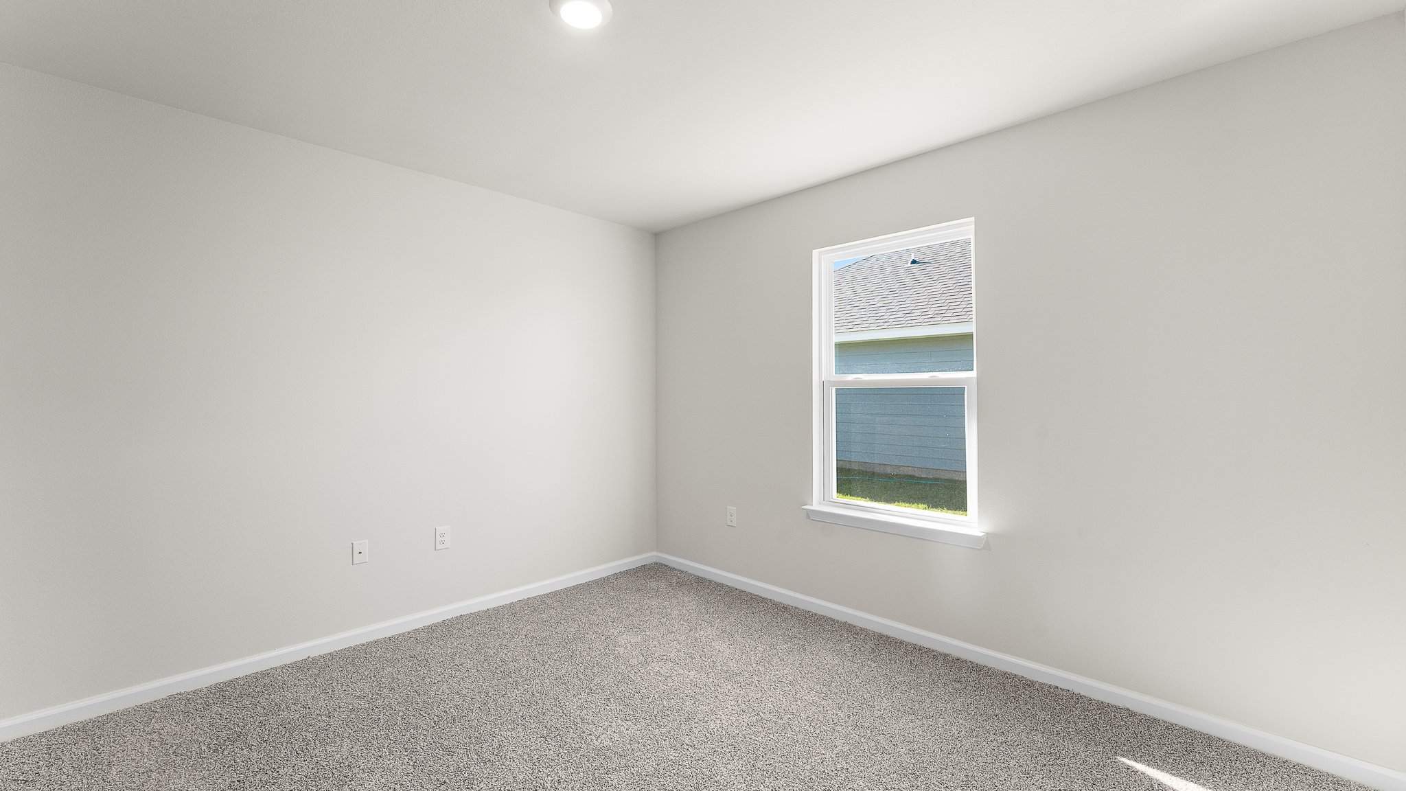 Bedroom with carpet floors and window.