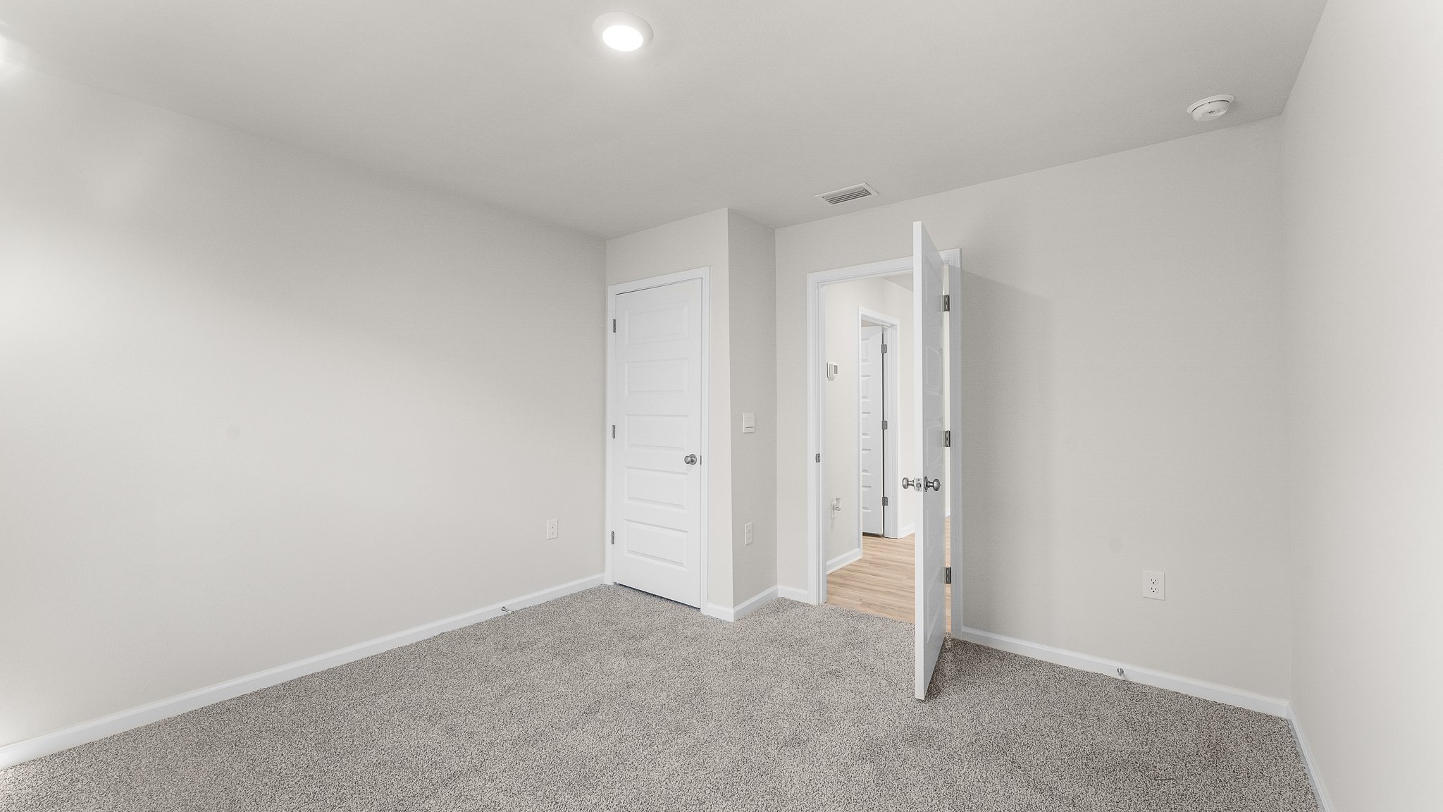 Bedroom with carpet floors and closet.