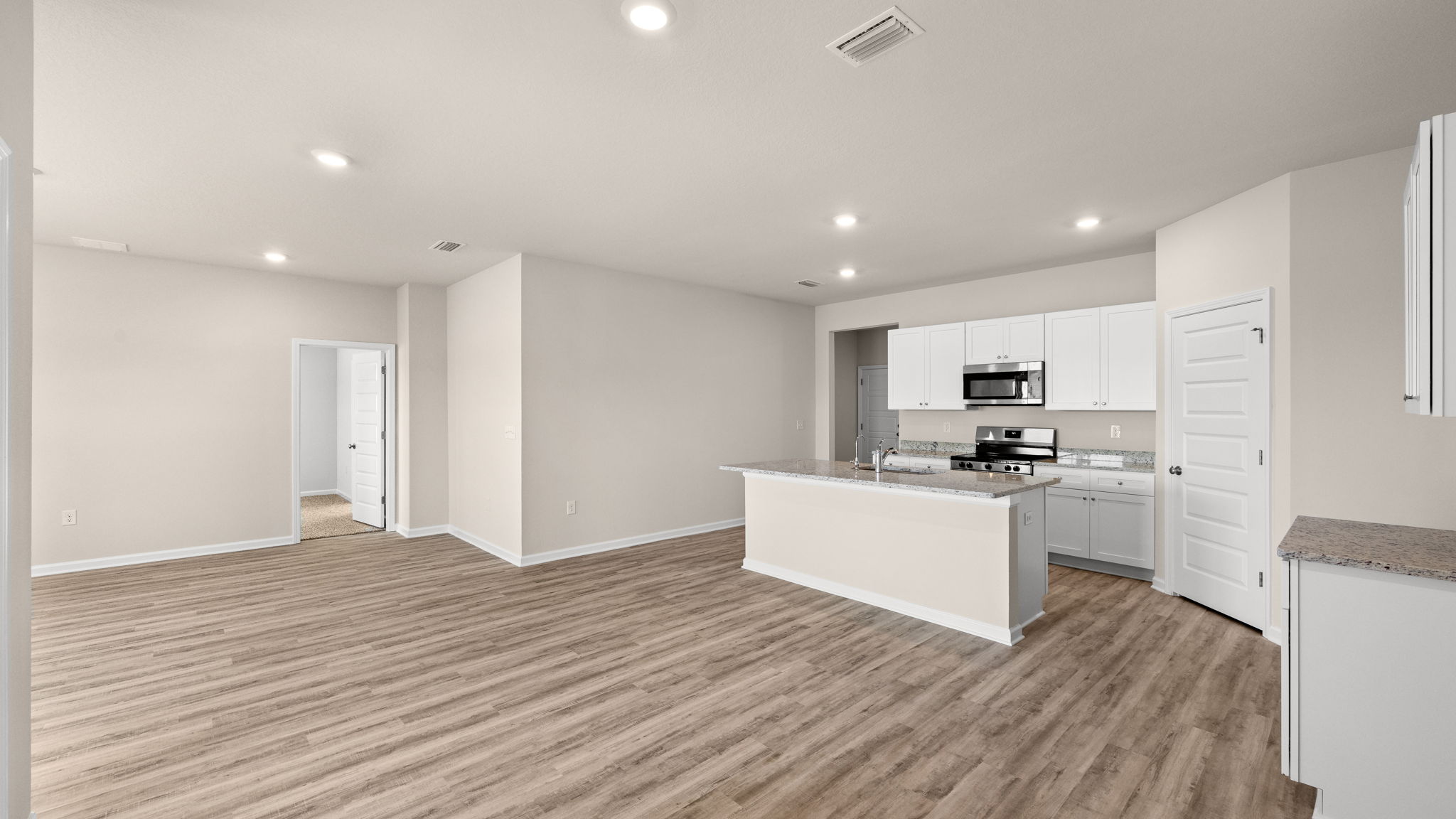 Living room and dining area next to back door.