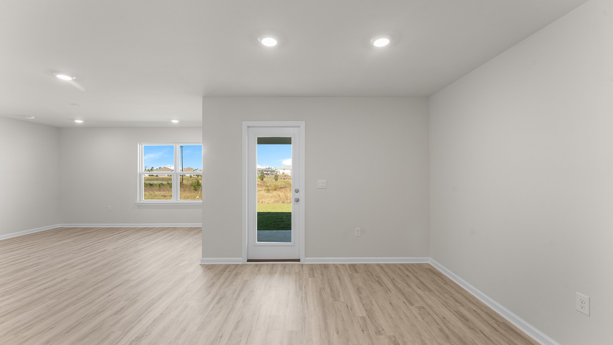 Dining room with EVP flooring and back door.