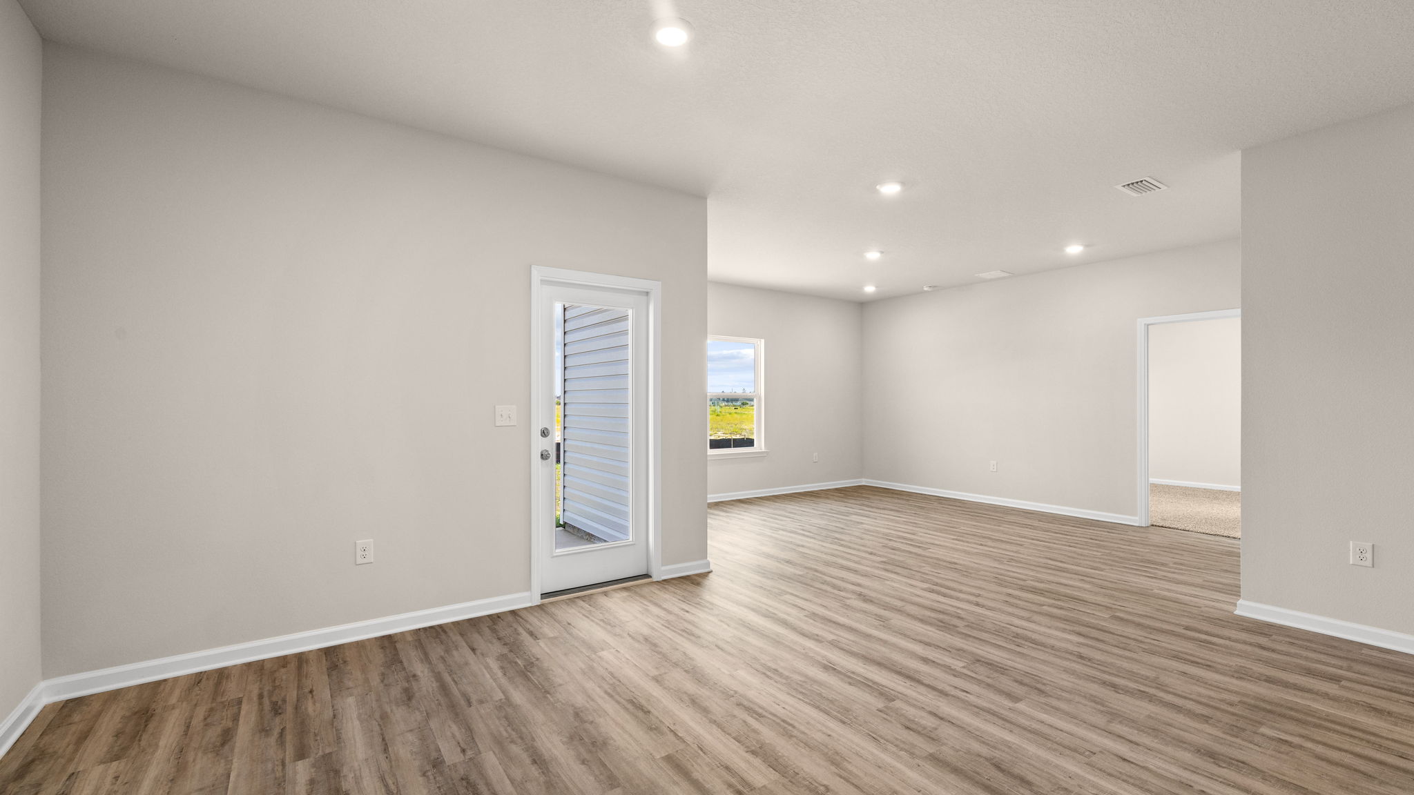 Living room and dining area next to back door.