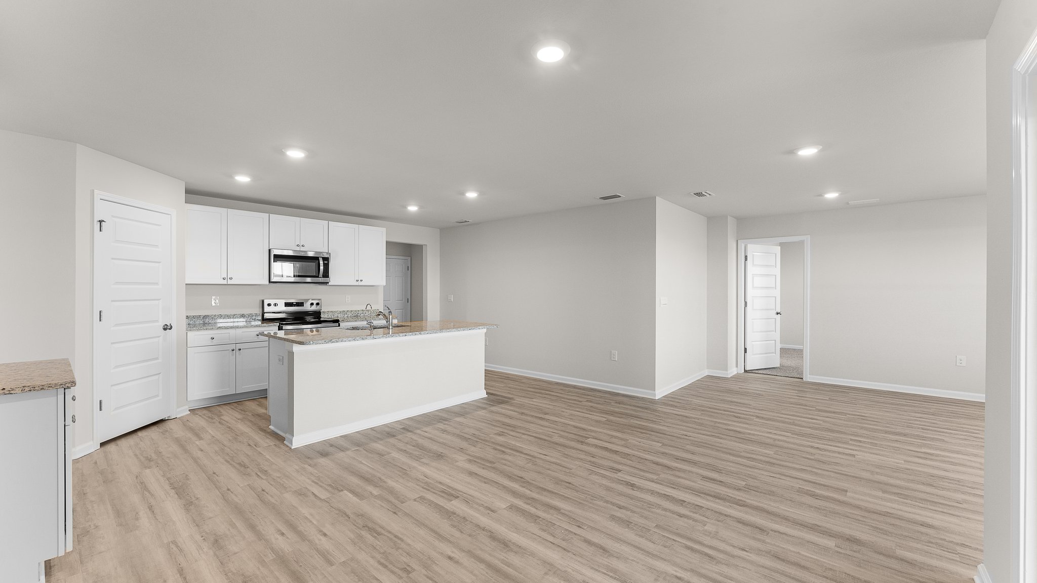 Open living room and kitchen with EVP flooring.