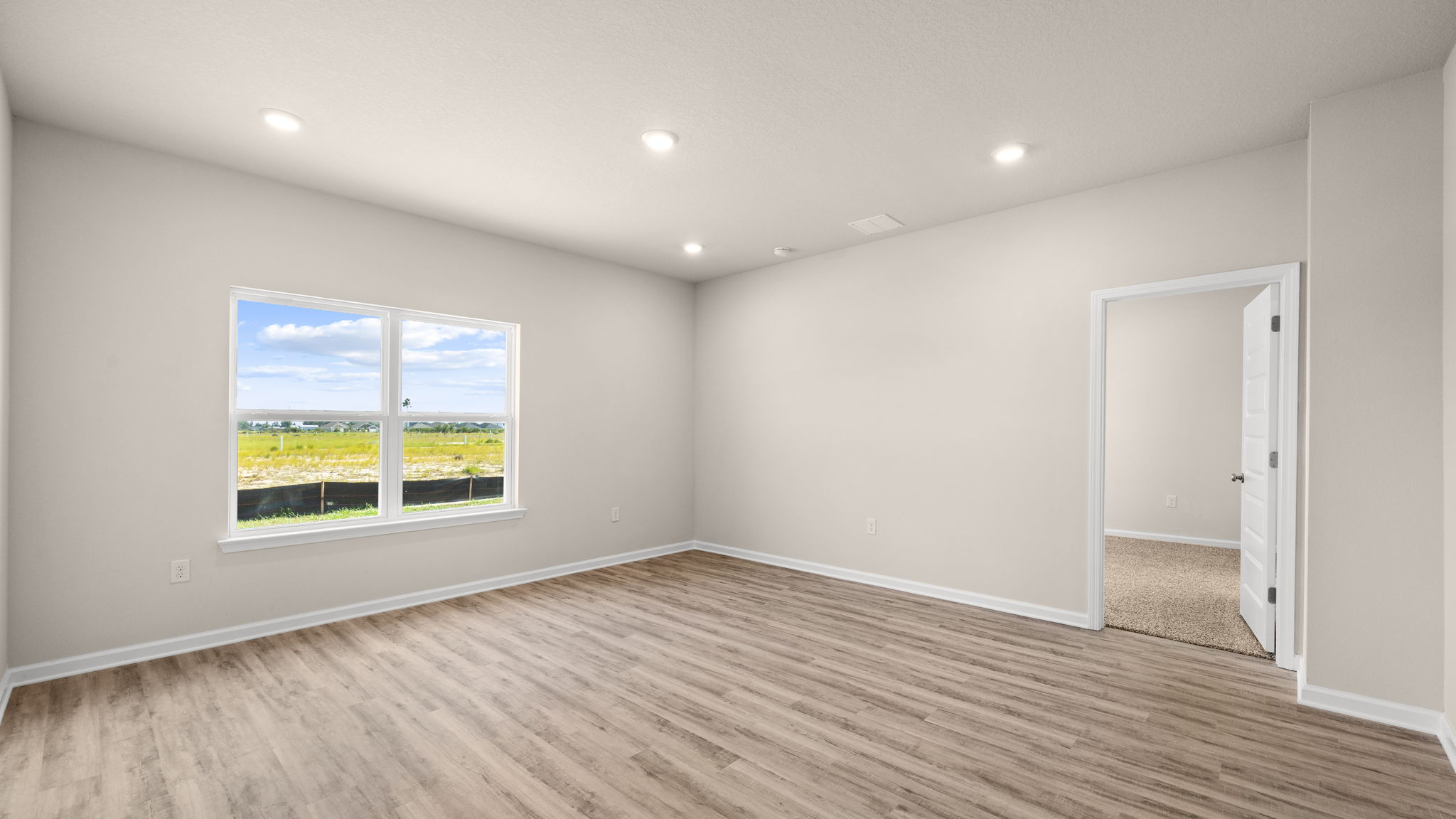 Living room and windows next to primary bedroom.