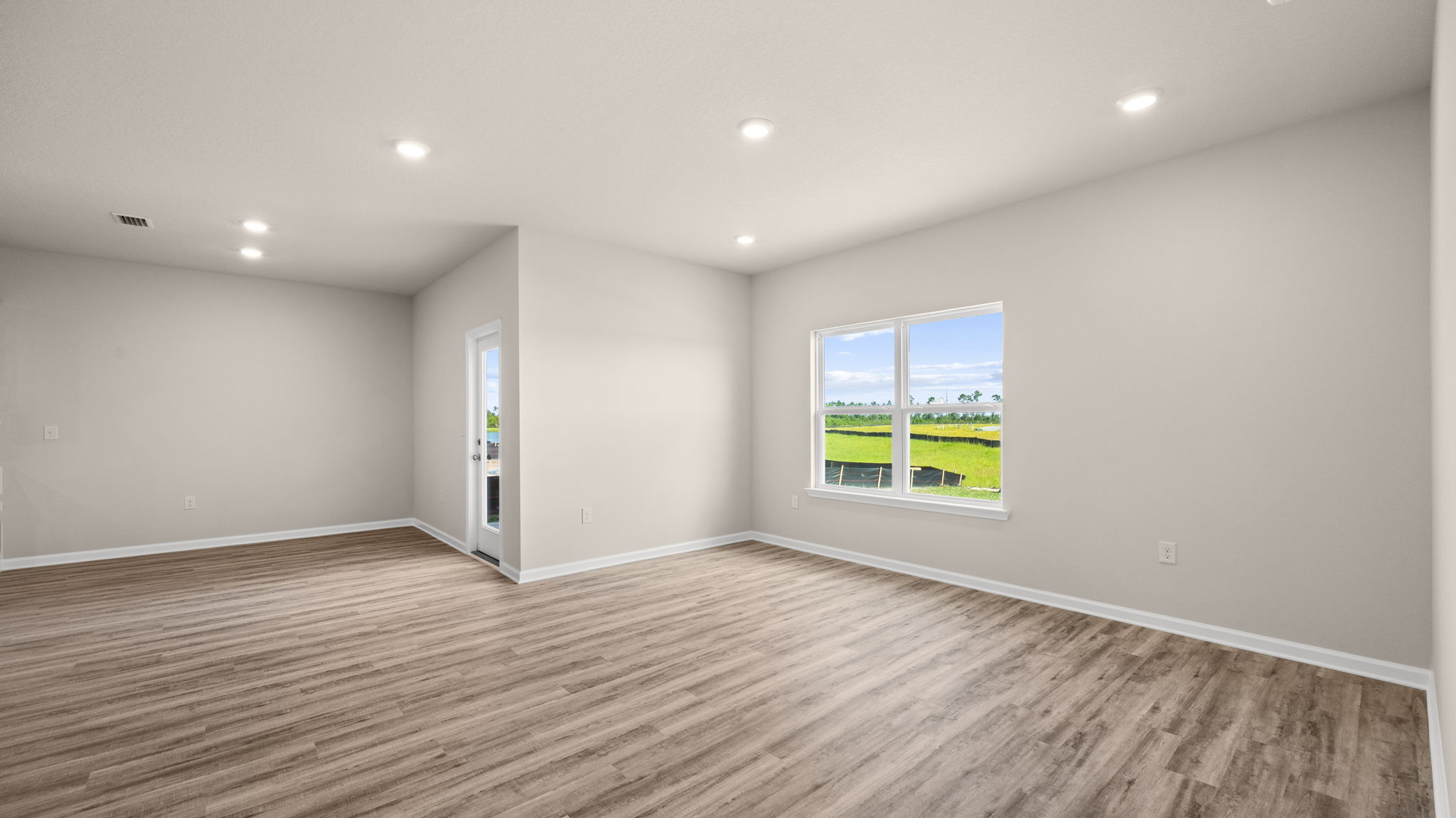 Living room and windows next to primary bedroom.