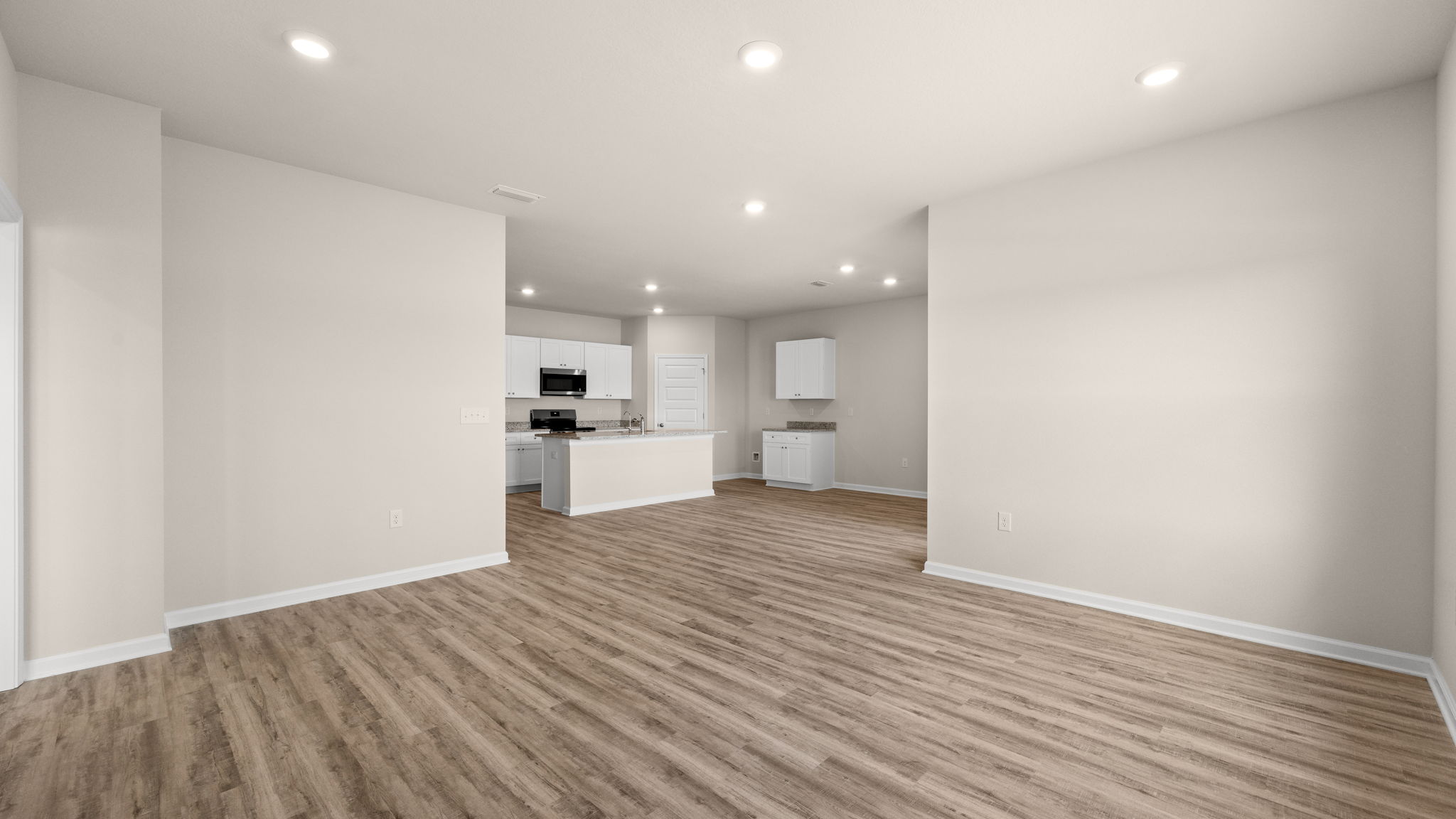 Living room and windows next to primary bedroom.