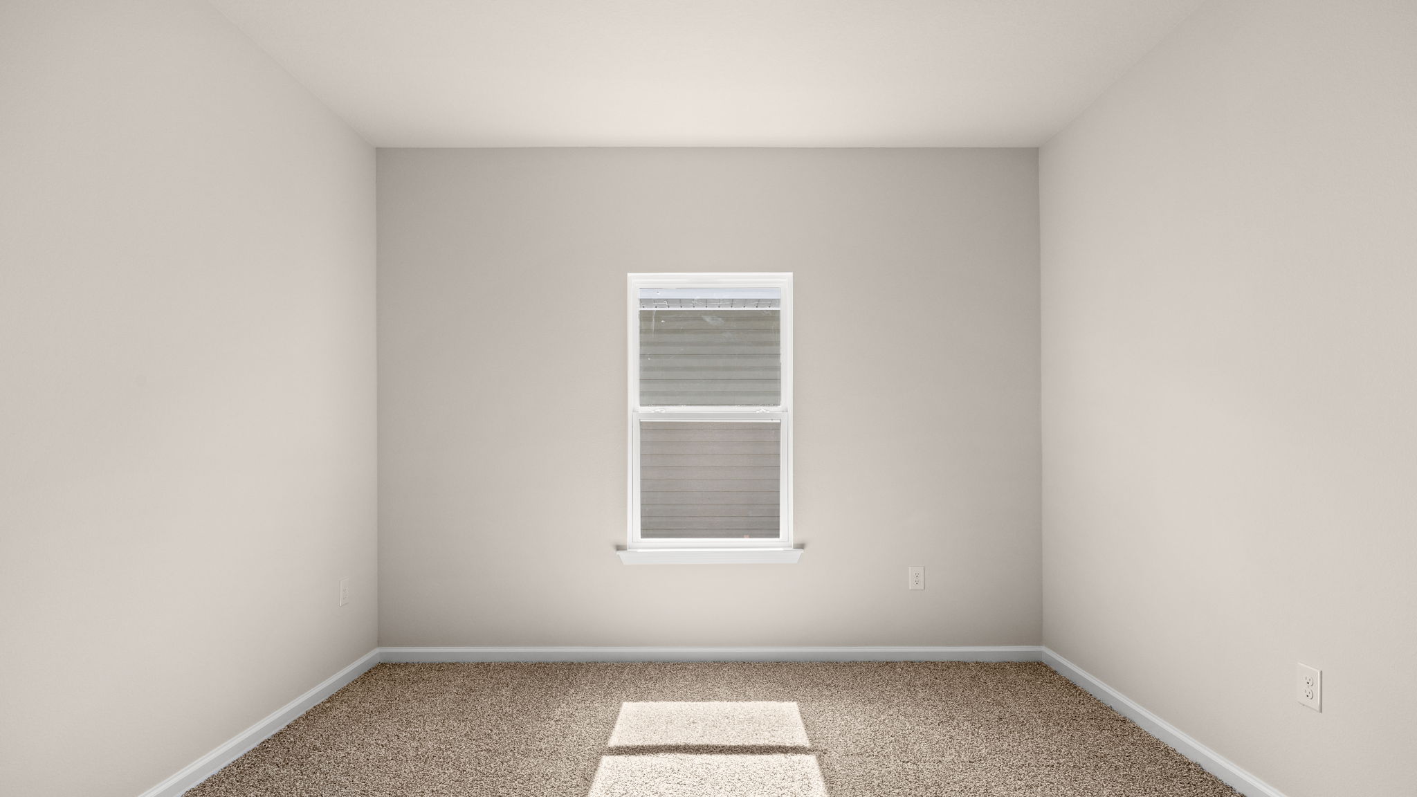 Bedroom with carpet floor and window.