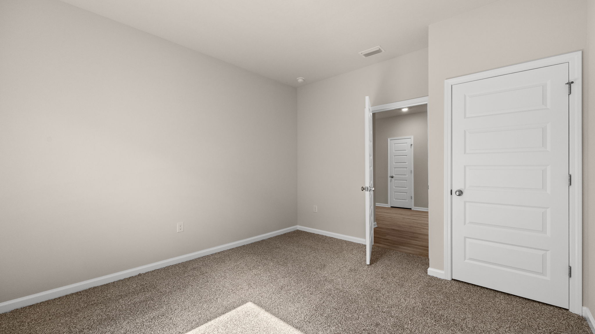 Bedroom with carpet floor and window.