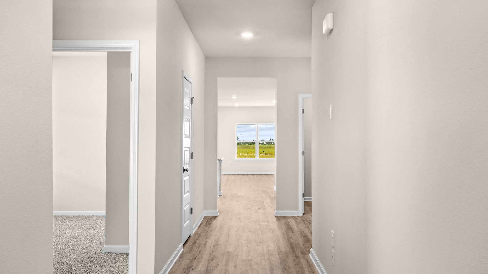 Front entrance hallway with EVP flooring next to garage and bedrooms.