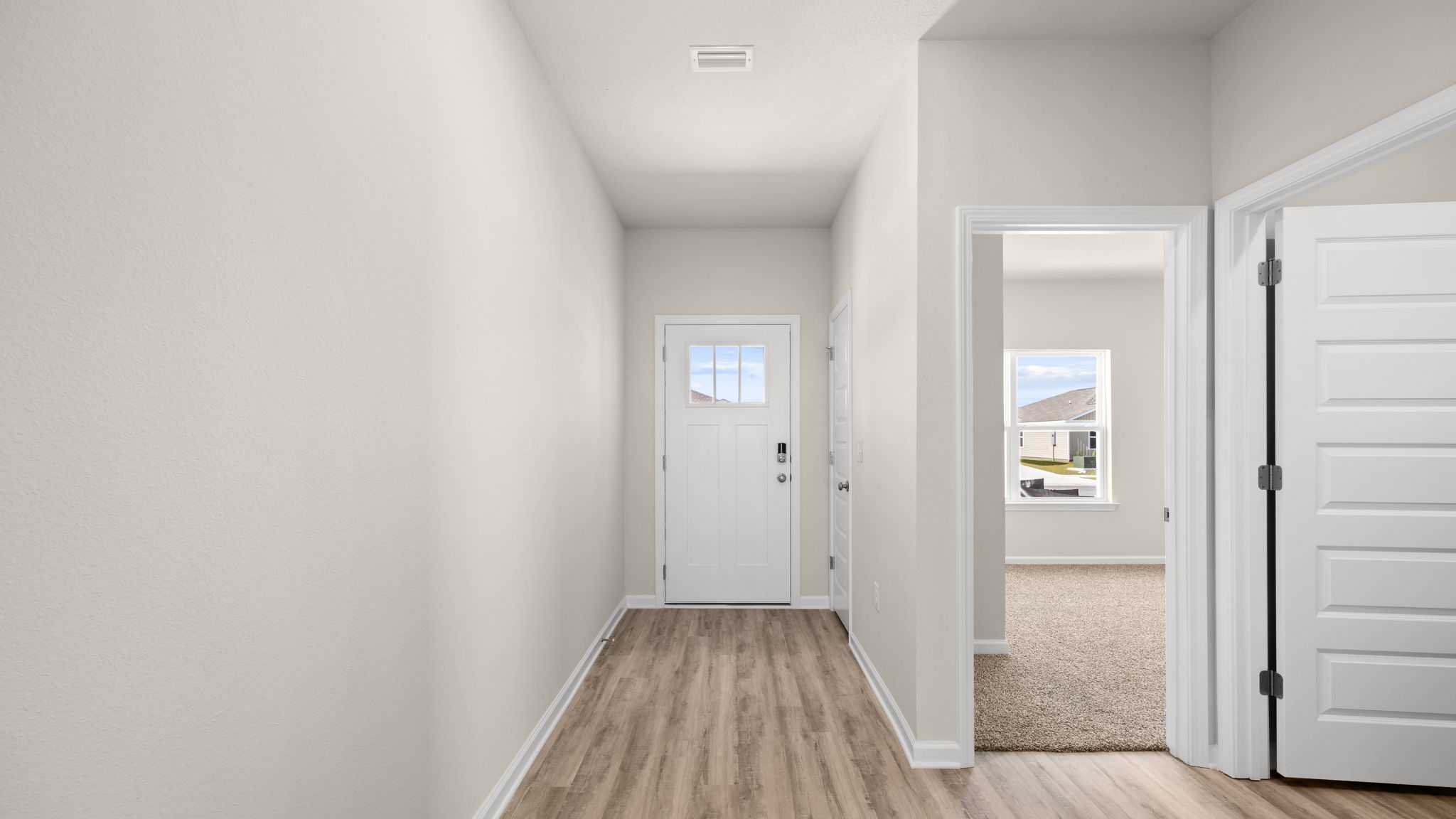 Front entrance hallway with EVP flooring next to garage and bedrooms.Front entrance hallway with EVP flooring next to garage and bedrooms.