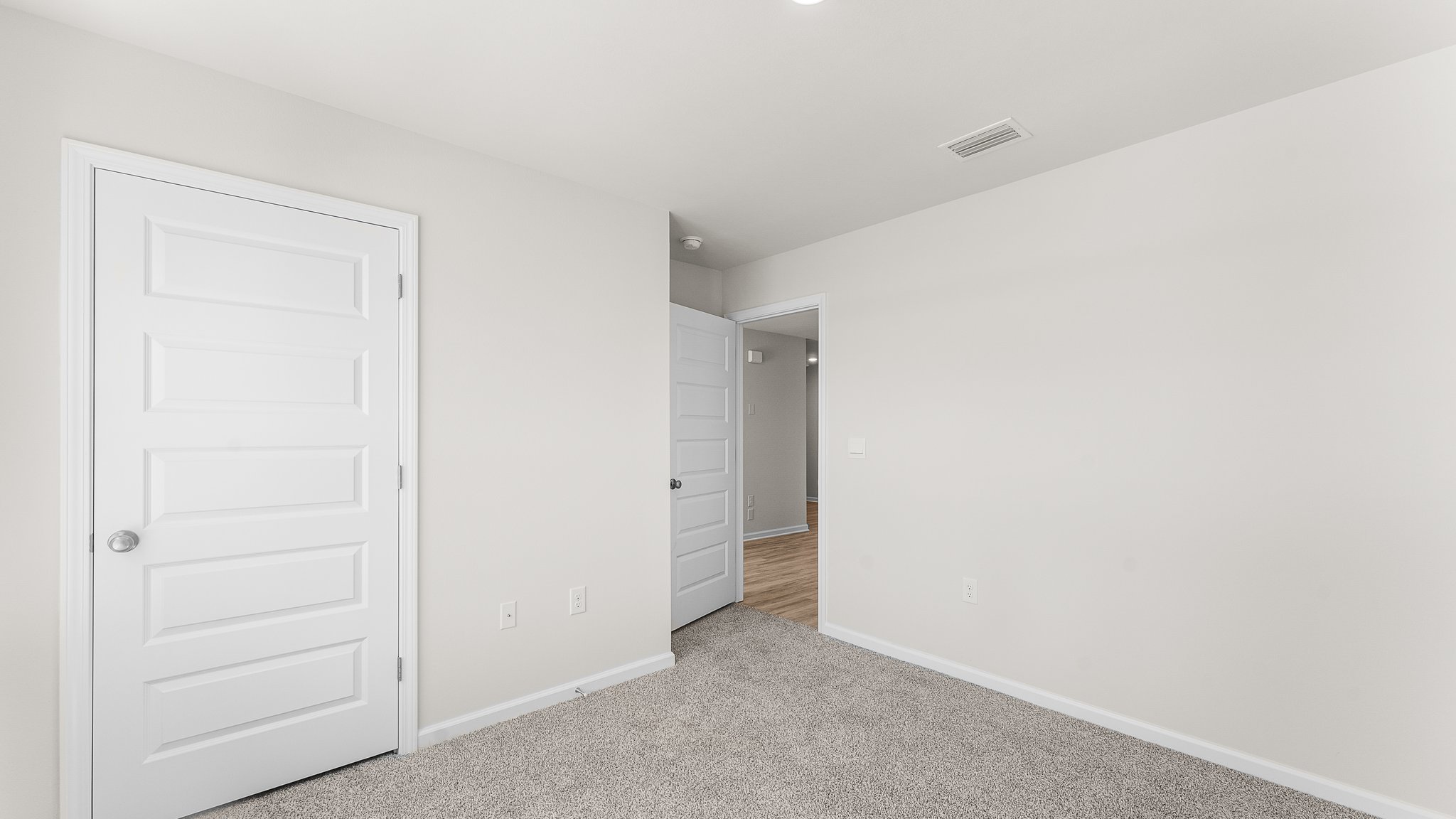 Bedroom with carpet floors and closet.