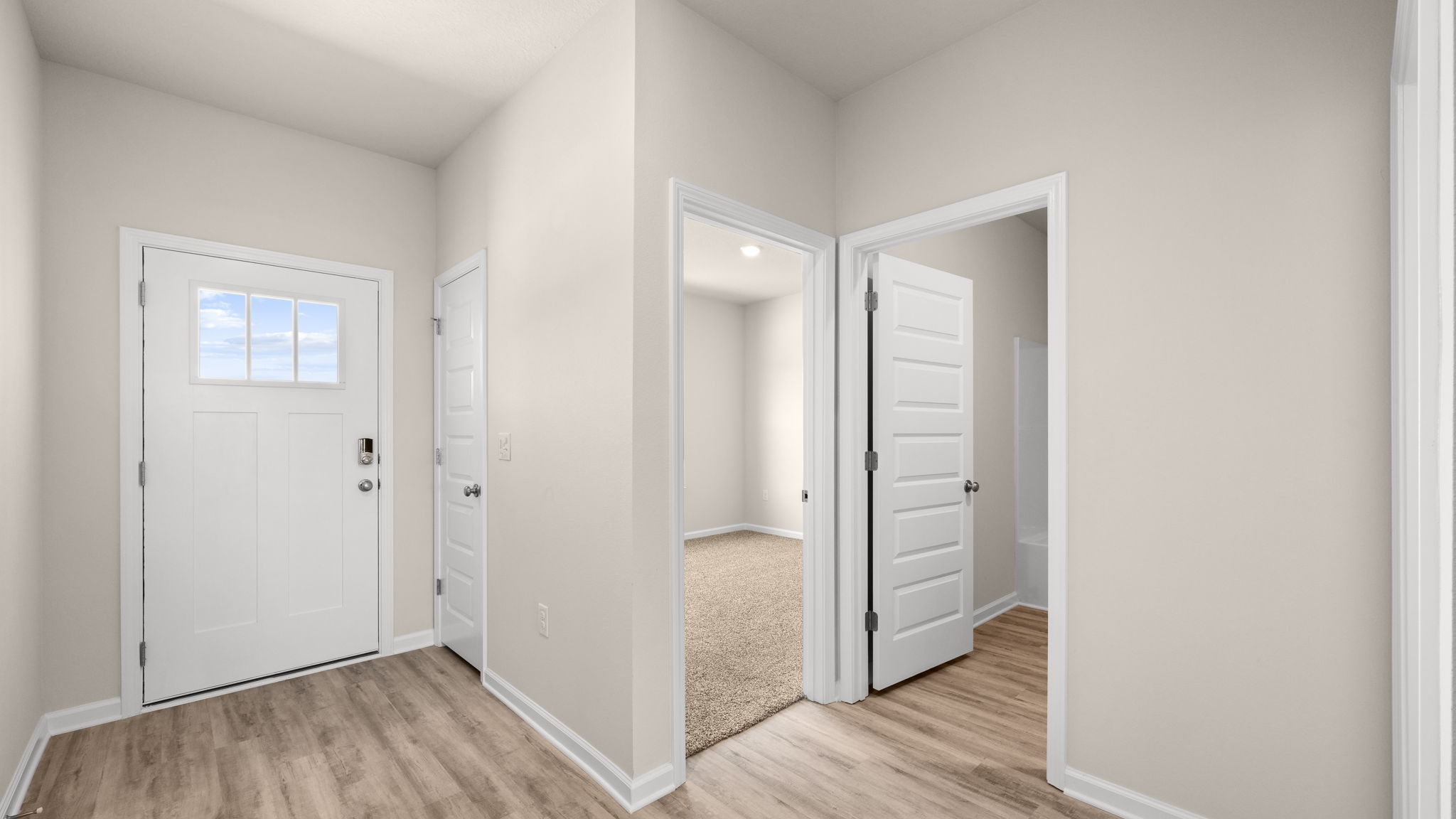 Front entrance hallway with EVP flooring next to garage and bedrooms.