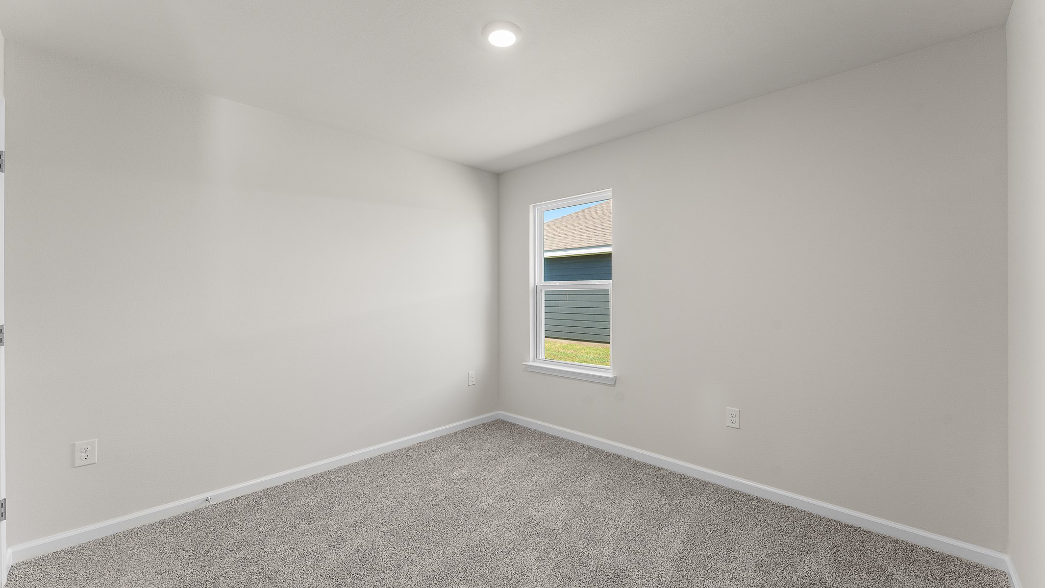 Bedroom with carpet floors and window.