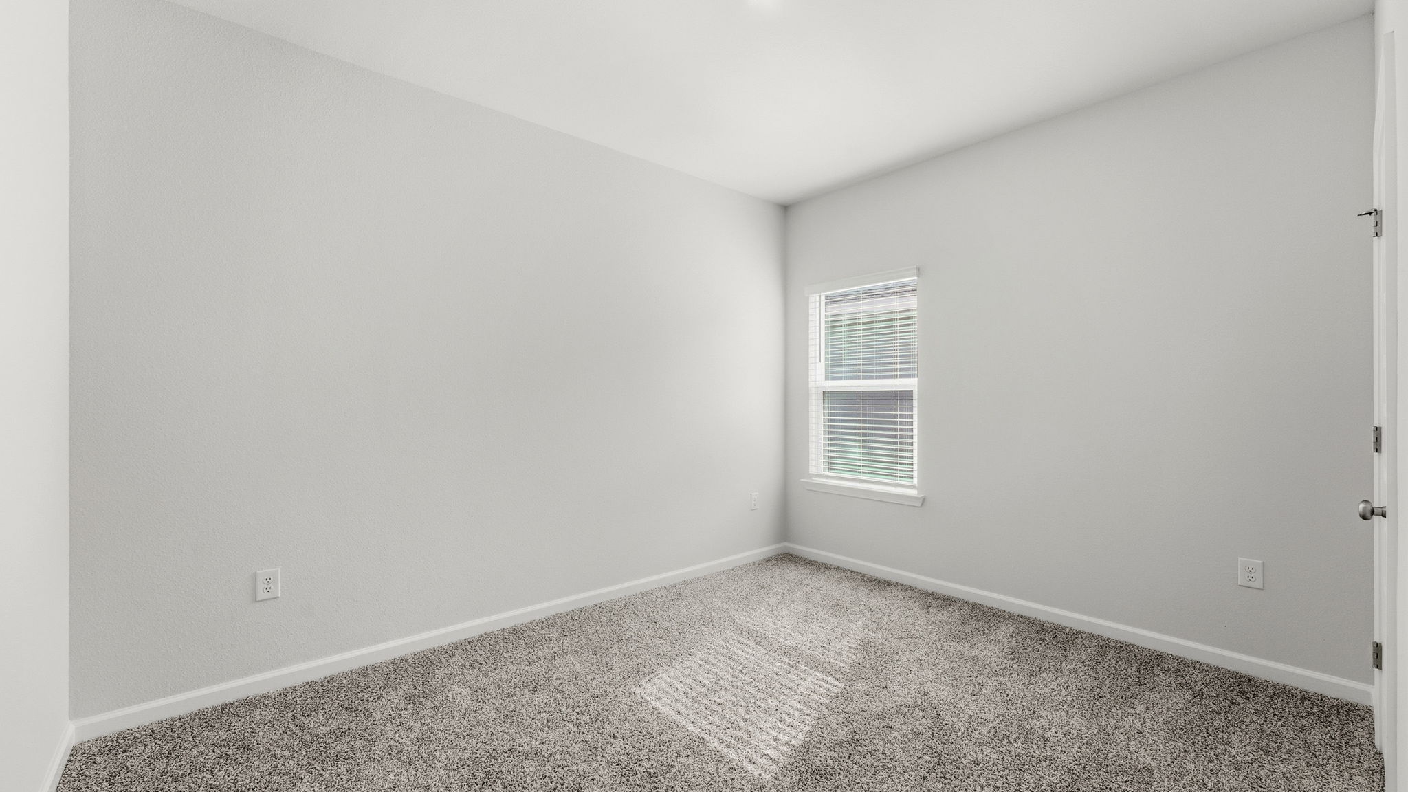 Bedroom with carpet floor and window and closet.