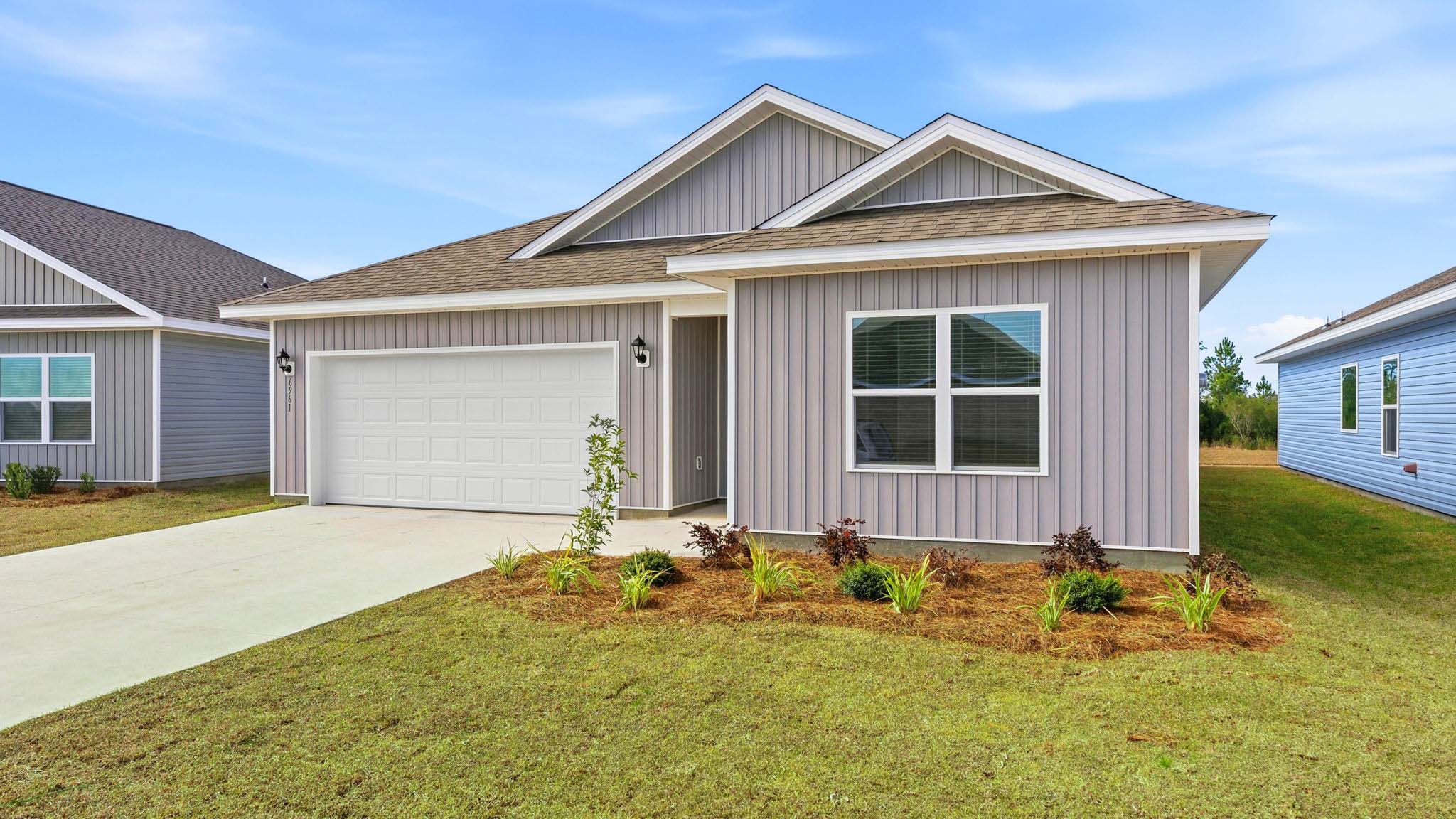 Creekside plan at Liberty front of home with vinyl siding and two car garage.
