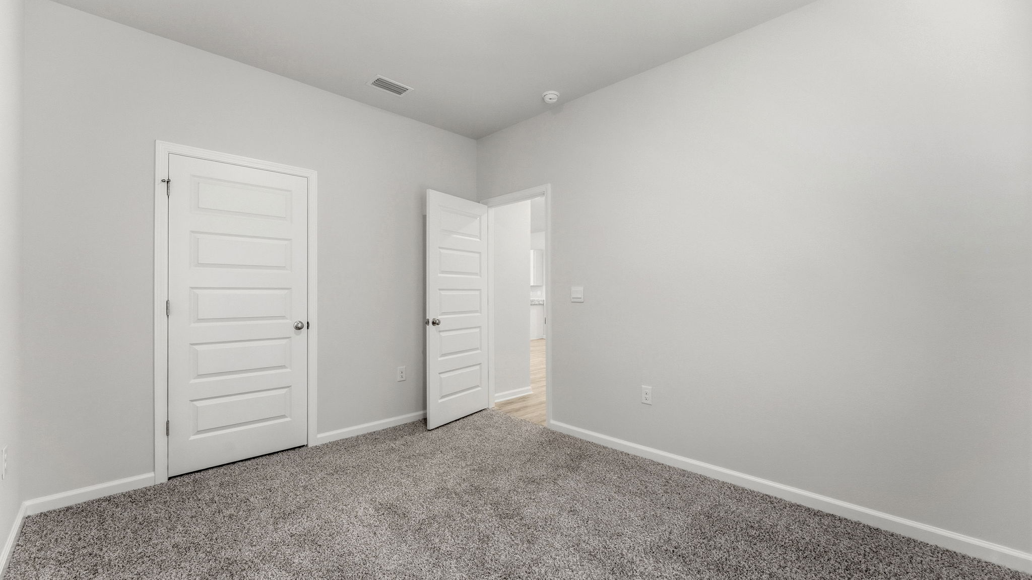 Bedroom with carpet floor and closet.