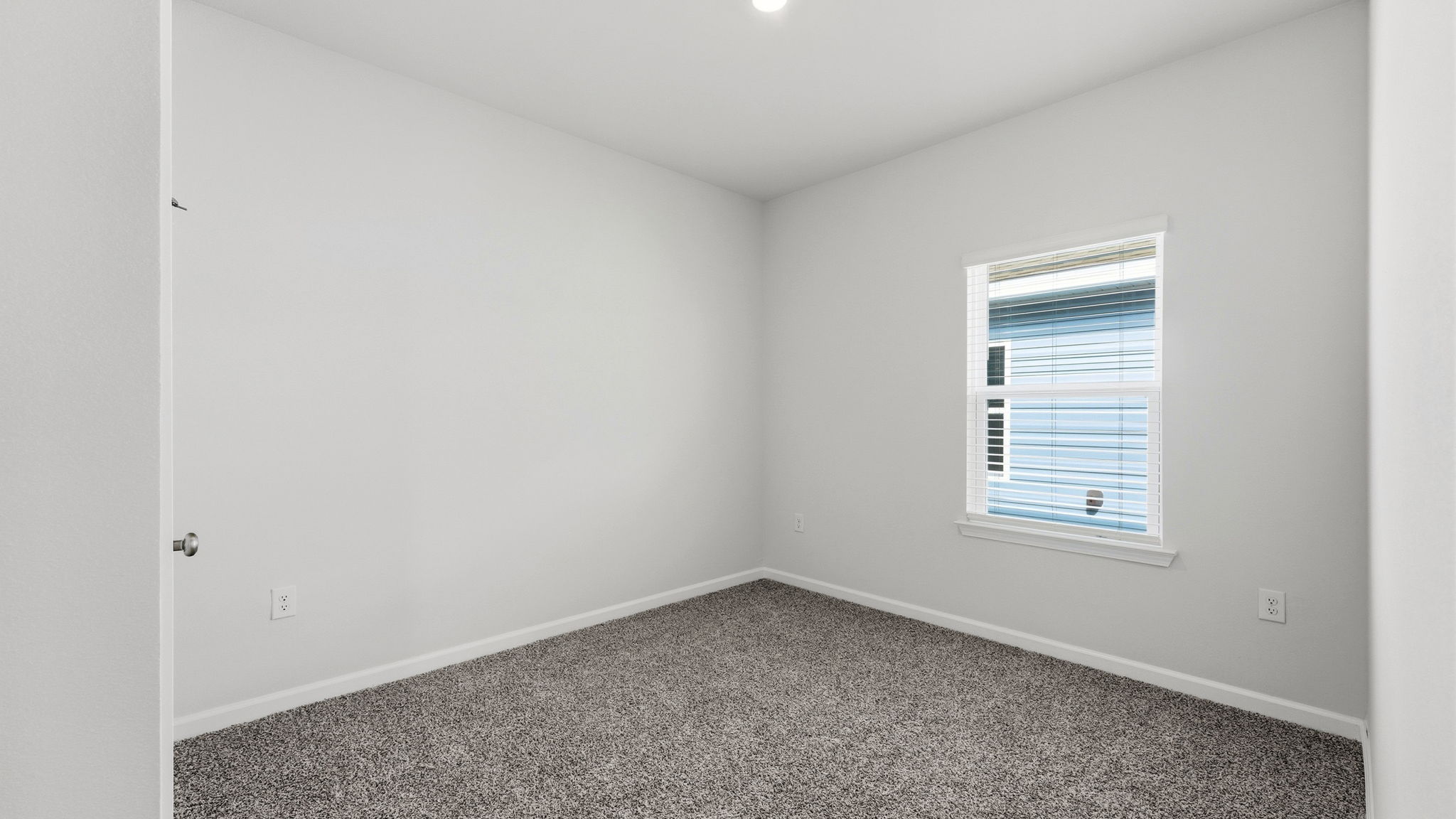 Bedroom with carpet floor and window and closet.