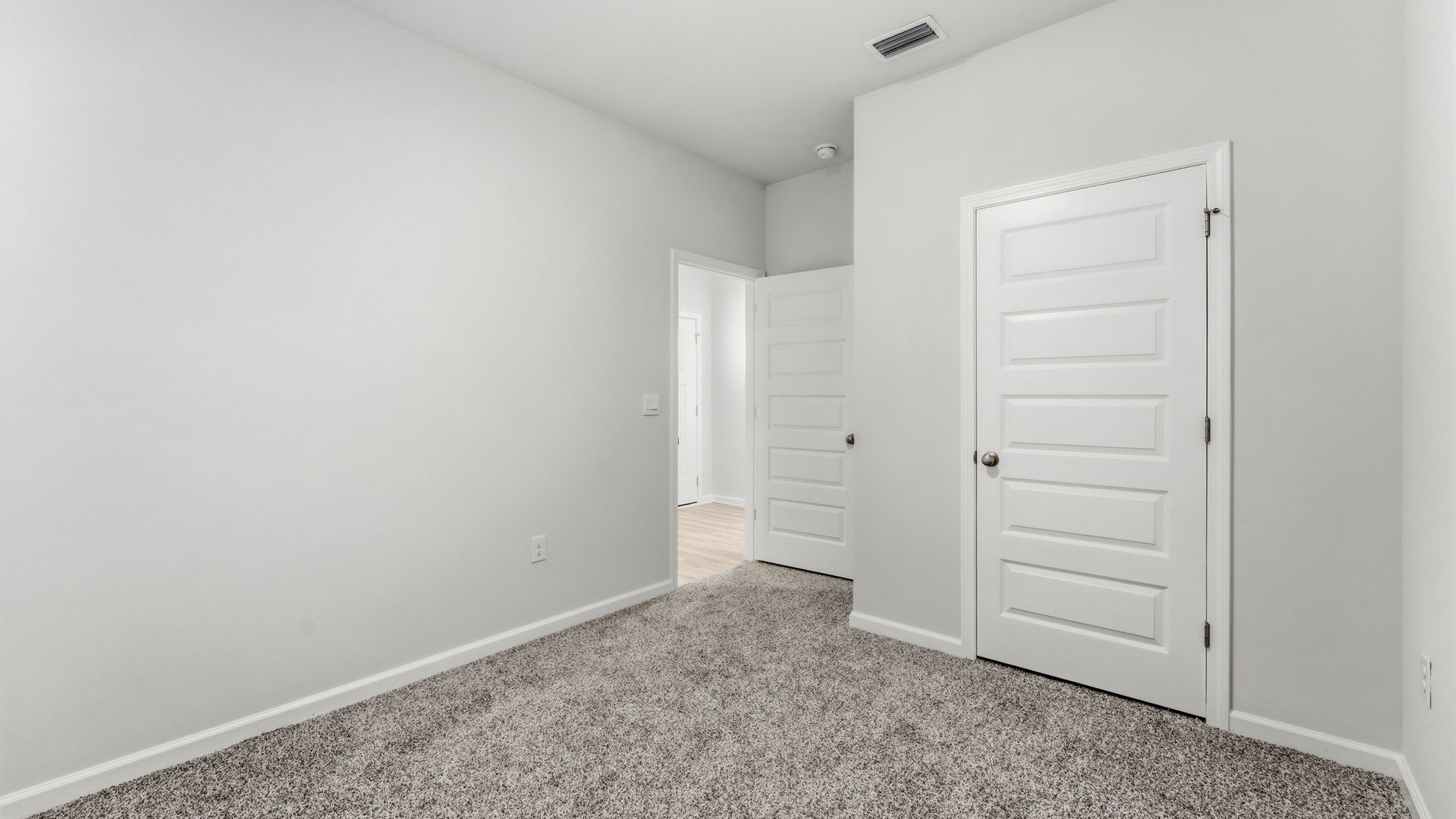 Bedroom with carpet floor and closet.