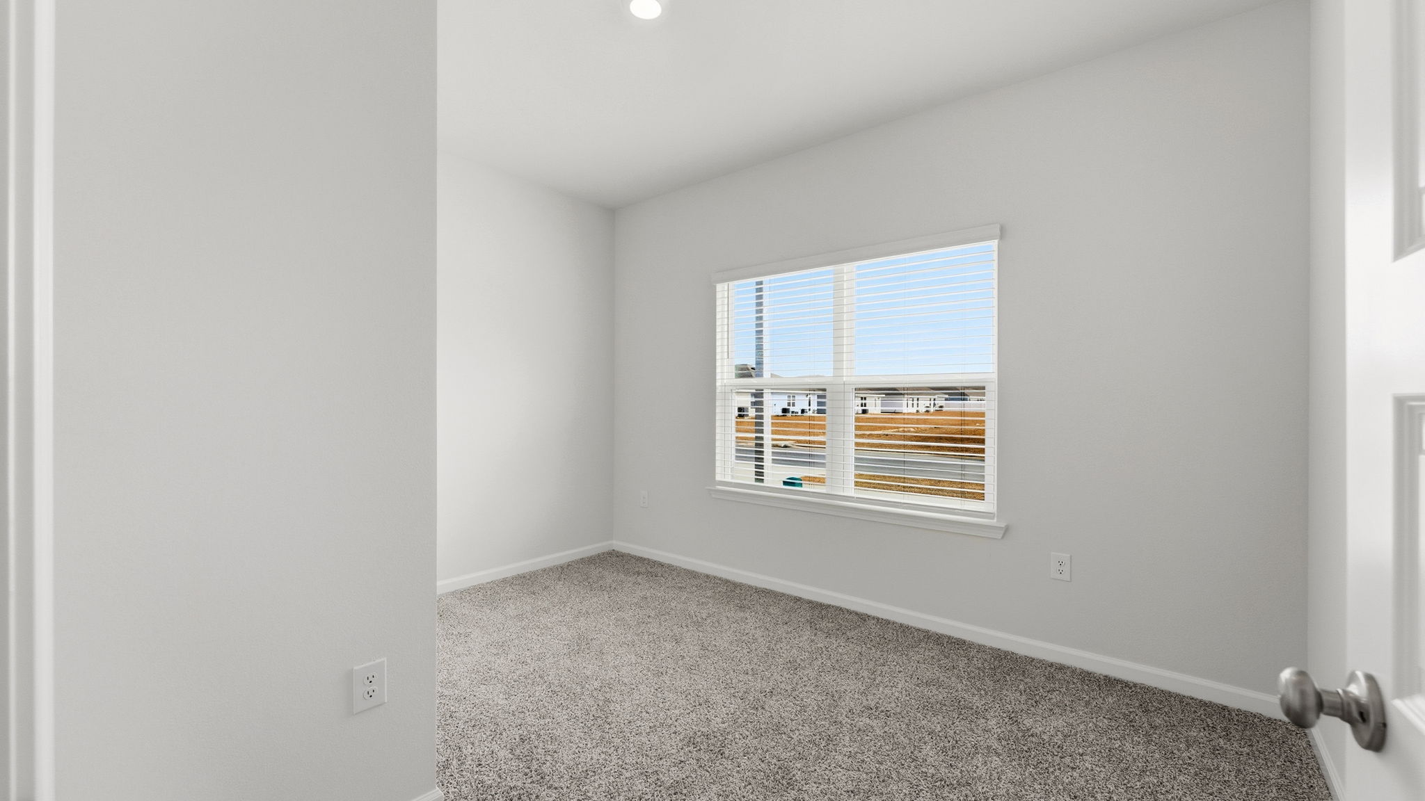 Bedroom with carpet floor and window and closet.