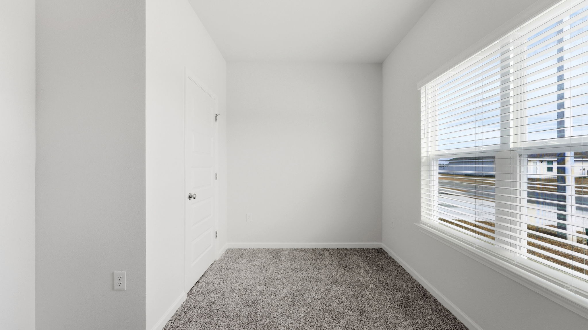 Bedroom with carpet floor and window and closet.