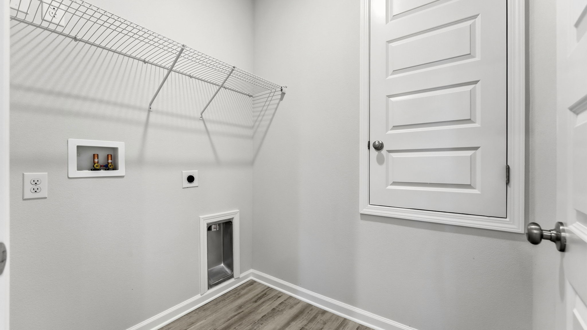 Laundry room with EVP flooring and ventilated shelving.