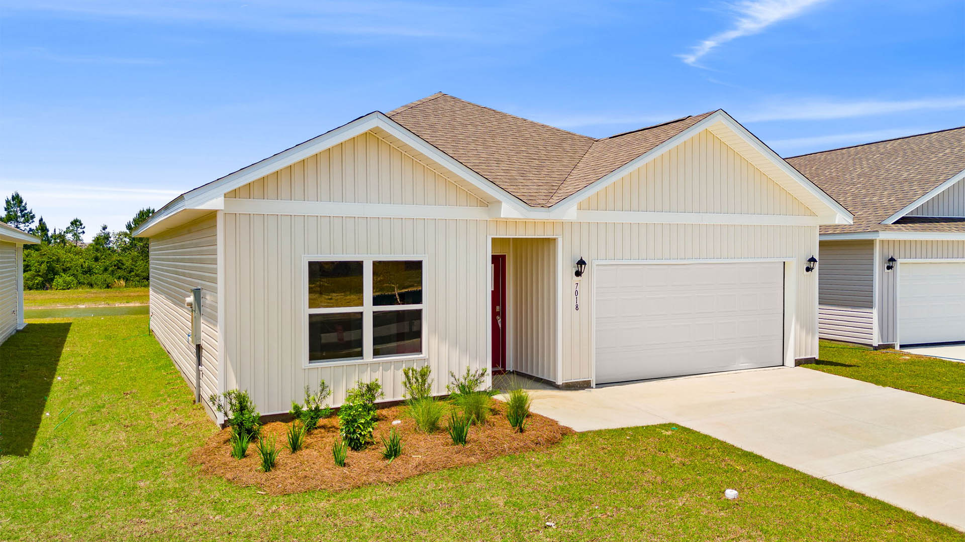 Eldridge plan at Liberty front of home with vinyl siding and two car garage.