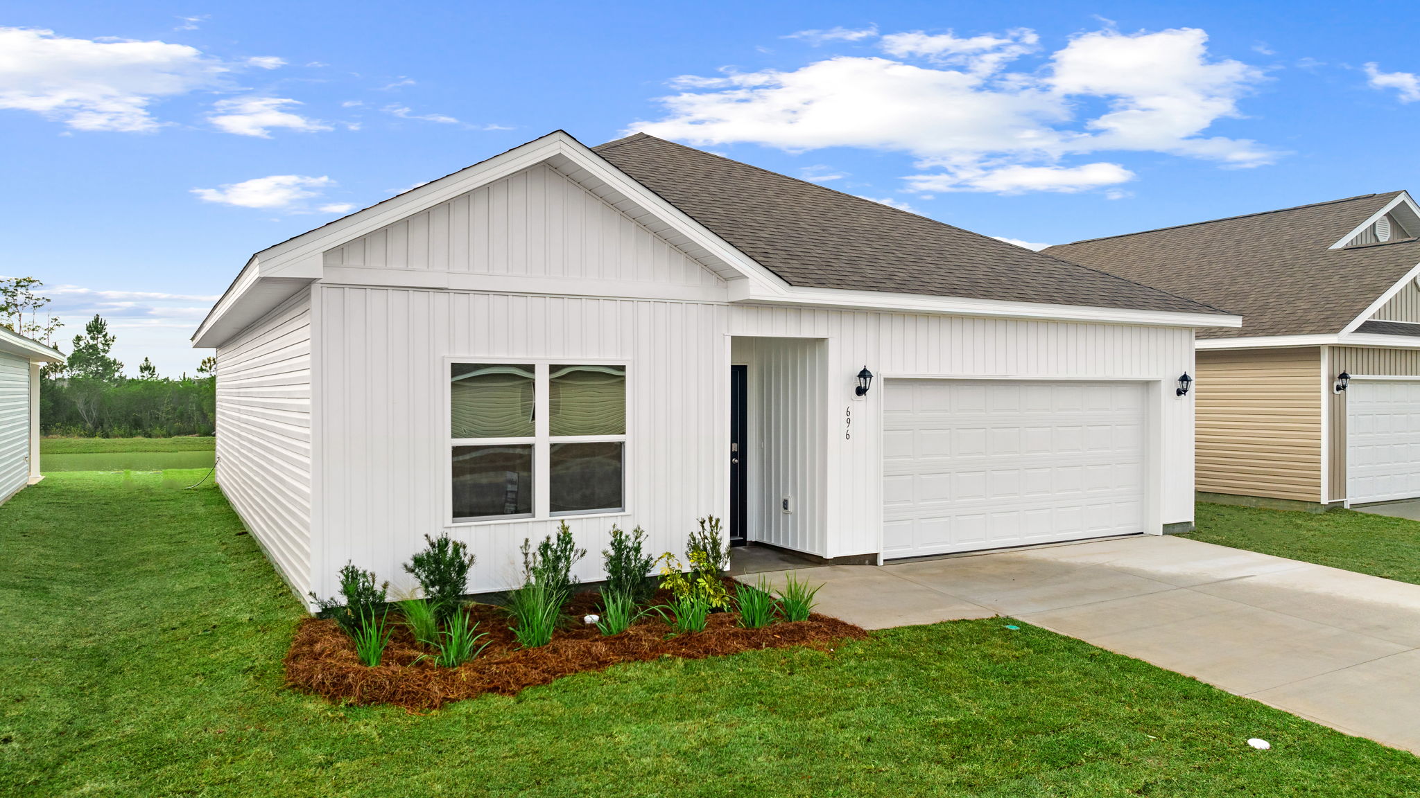 Eldridge plan at Liberty front of home with vinyl siding and two car garage.