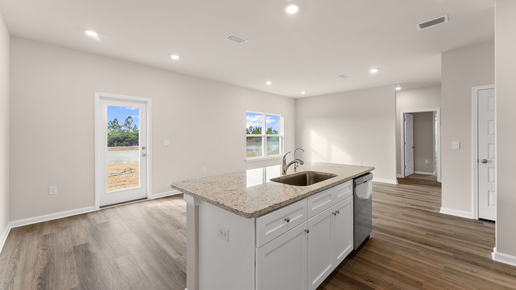 Kitchen and living room view with kitchen island.