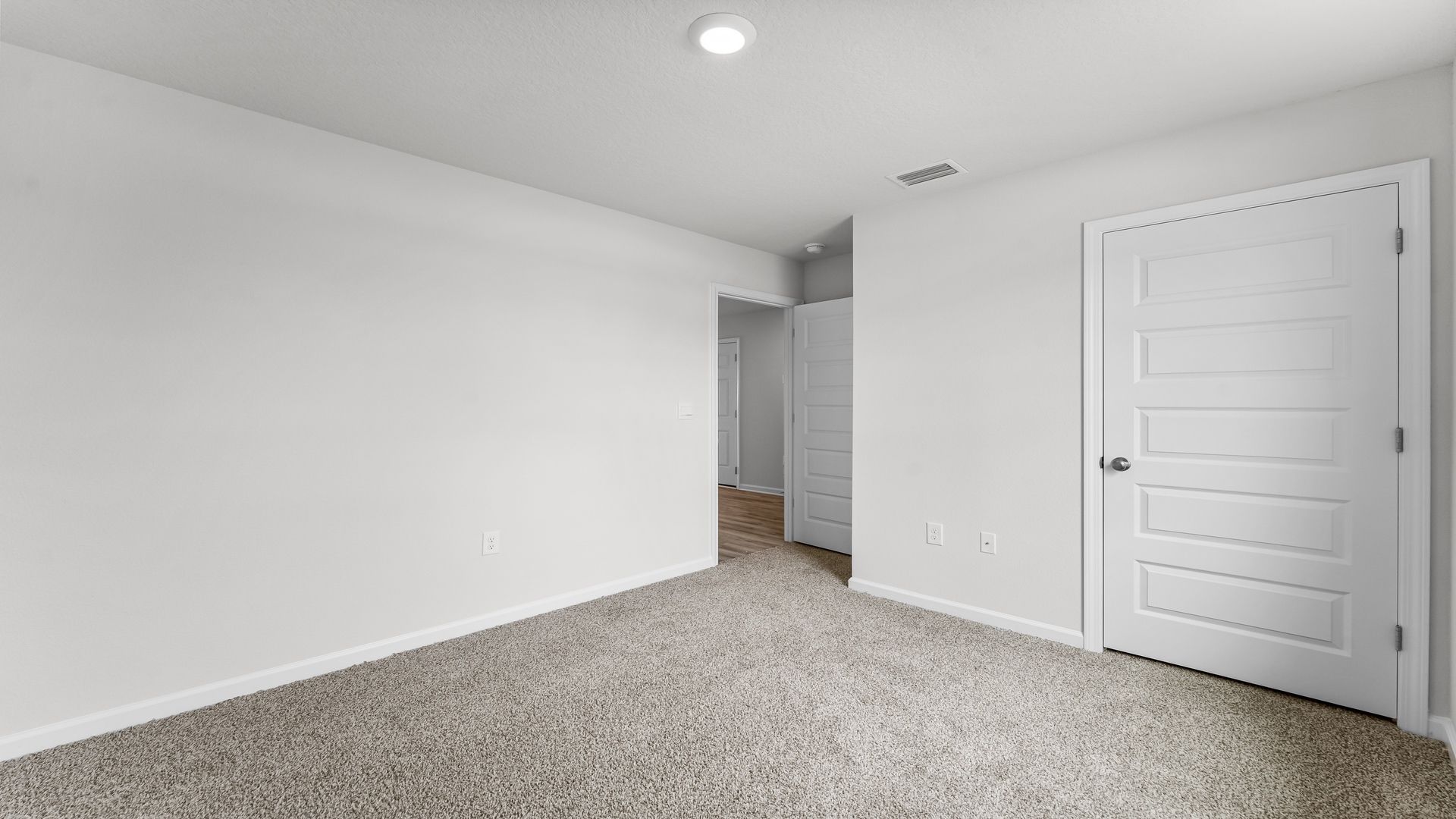 Bedroom with carpet flooring and closet.