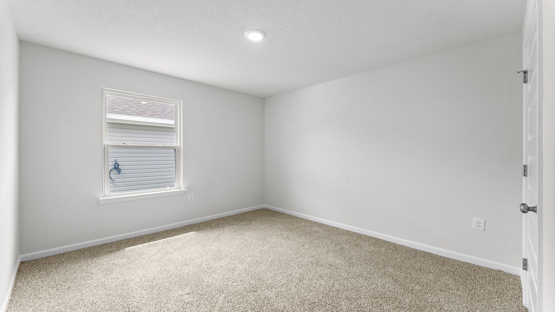 Bedroom with carpet flooring and window and closet.