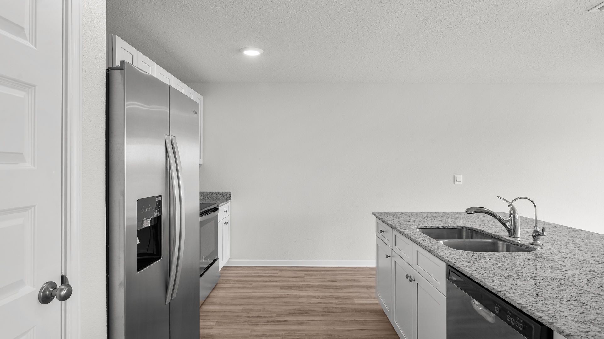 Kitchen island with granite countertops and stainless-steel appliances and pantry.