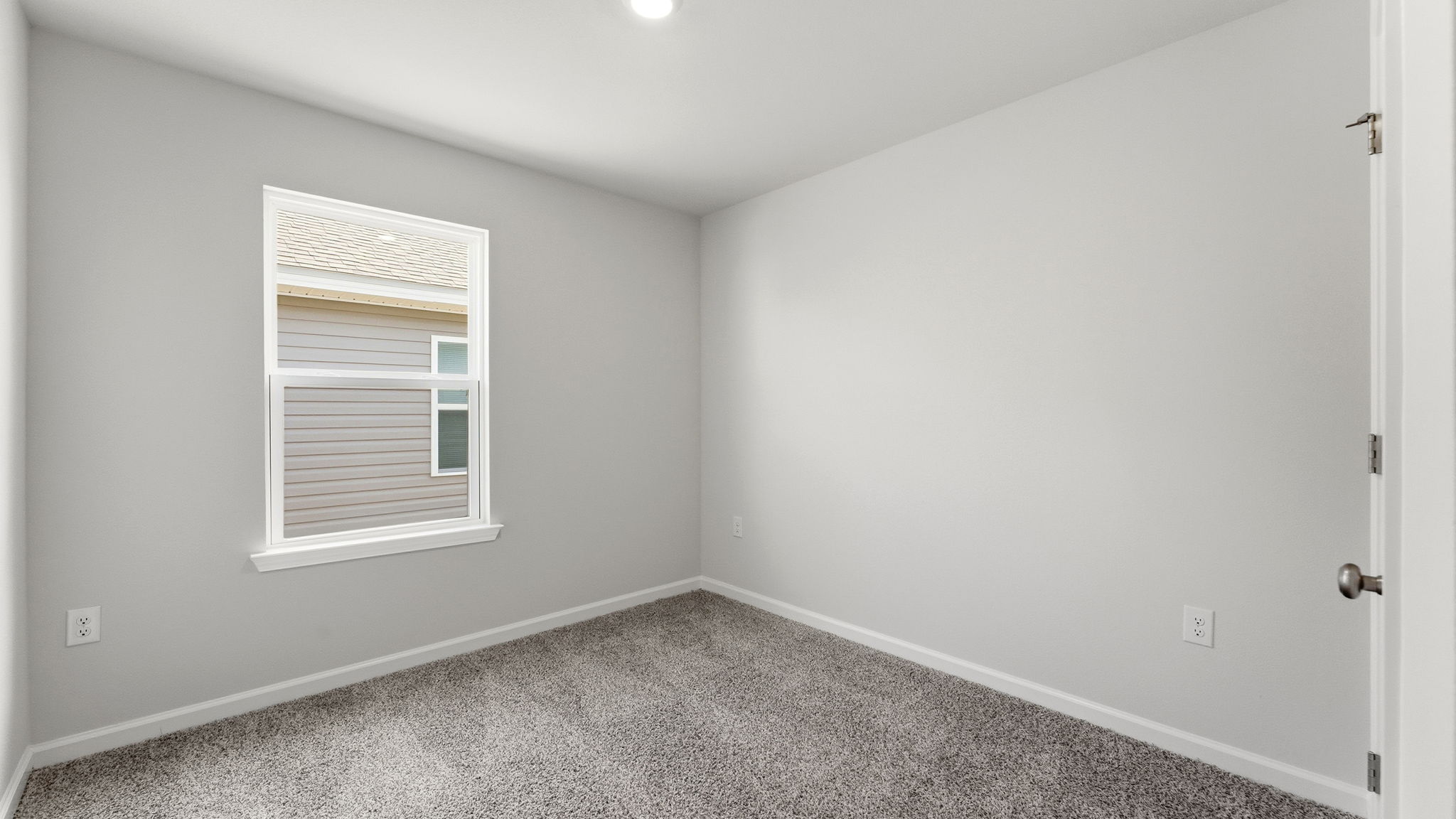 Bedroom with carpet flooring and window and closet.