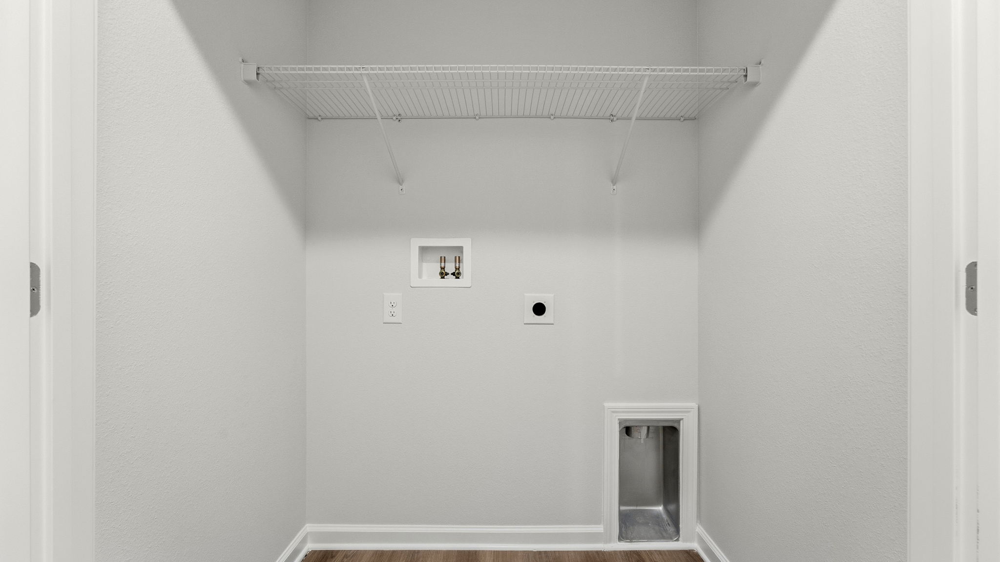 Laundry room with EVP flooring and ventilated shelving.